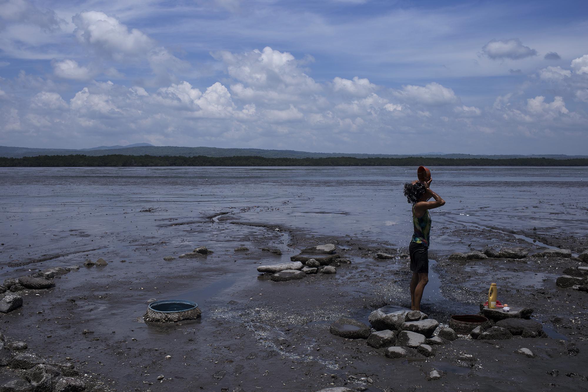 En medio de ese desierto que genera la bajada del mar por cuatro horas, Oneyda Mendoza, de 25 años, toma un baño a media mañana. En esa isla, el mar es el que manda en su rutina.