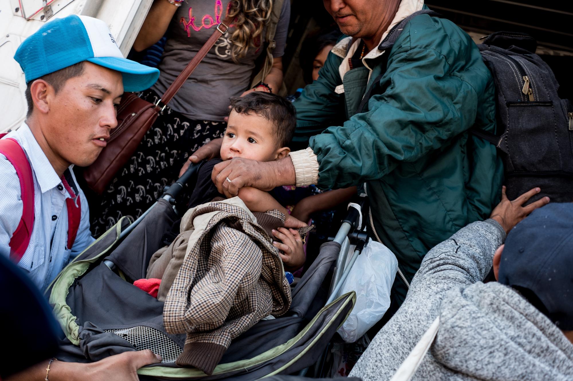 Migrantes centroamericanos  de la caravana se bajan de un trailer que les dio aventón desde Mexicali hasta el albergue en Tijuana, Baja California, el 20 de noviembre de 2018. Foto: Fred Ramos