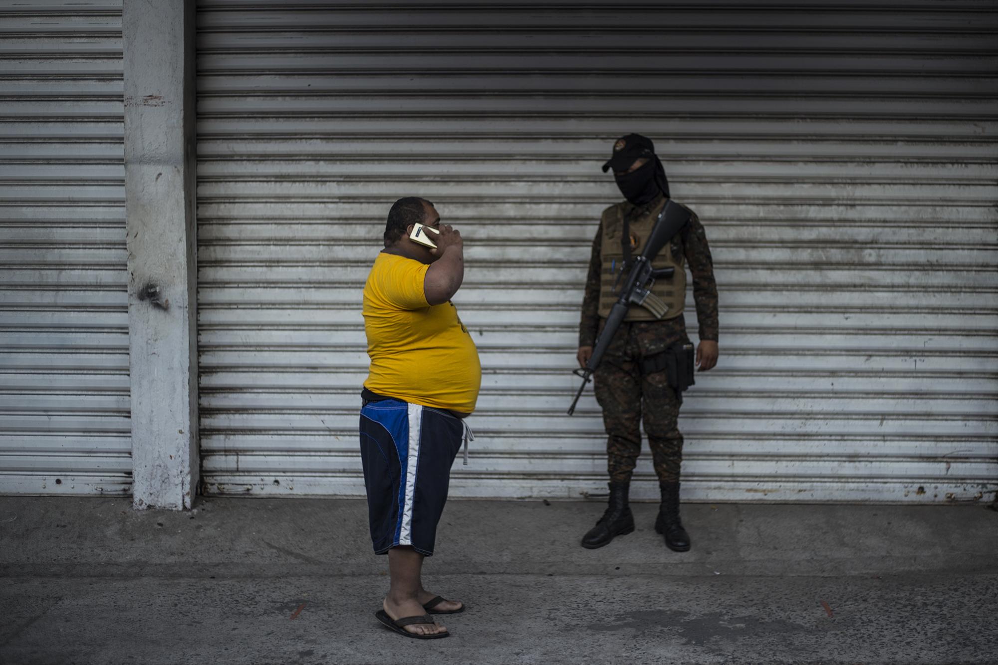 A group of soldiers stopped this man from continuing down 1 Avenue North. After a brief conversation, he returned to his home near the town marketplace.