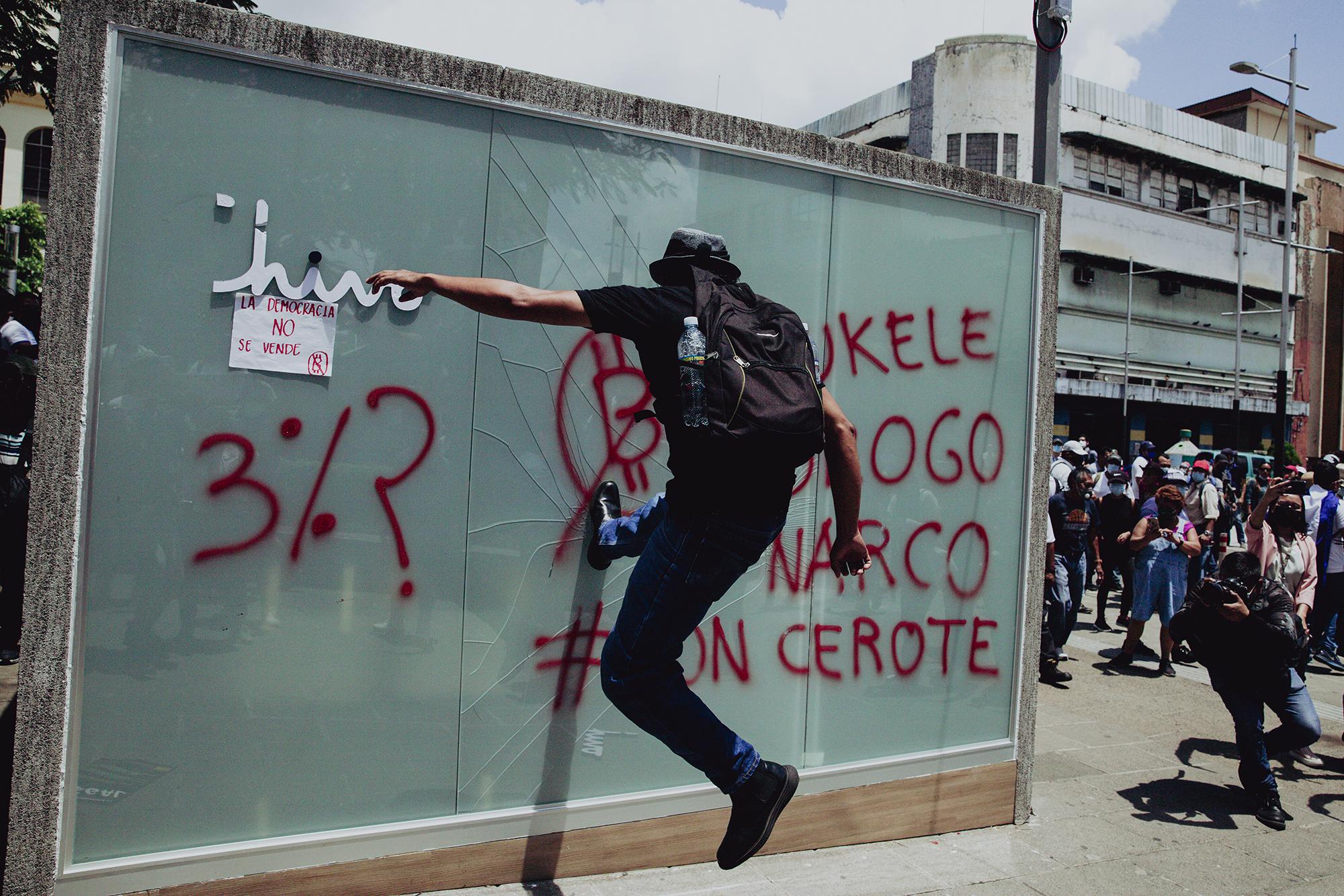 Mientras la mayor parte de los asistentes a la protesta se concentraban en la plaza Morazán, un reducido grupo destrozó la cabina del cajero Chivo en la plaza Gerardo Barrios. Foto de El Faro: Carlos Barrera