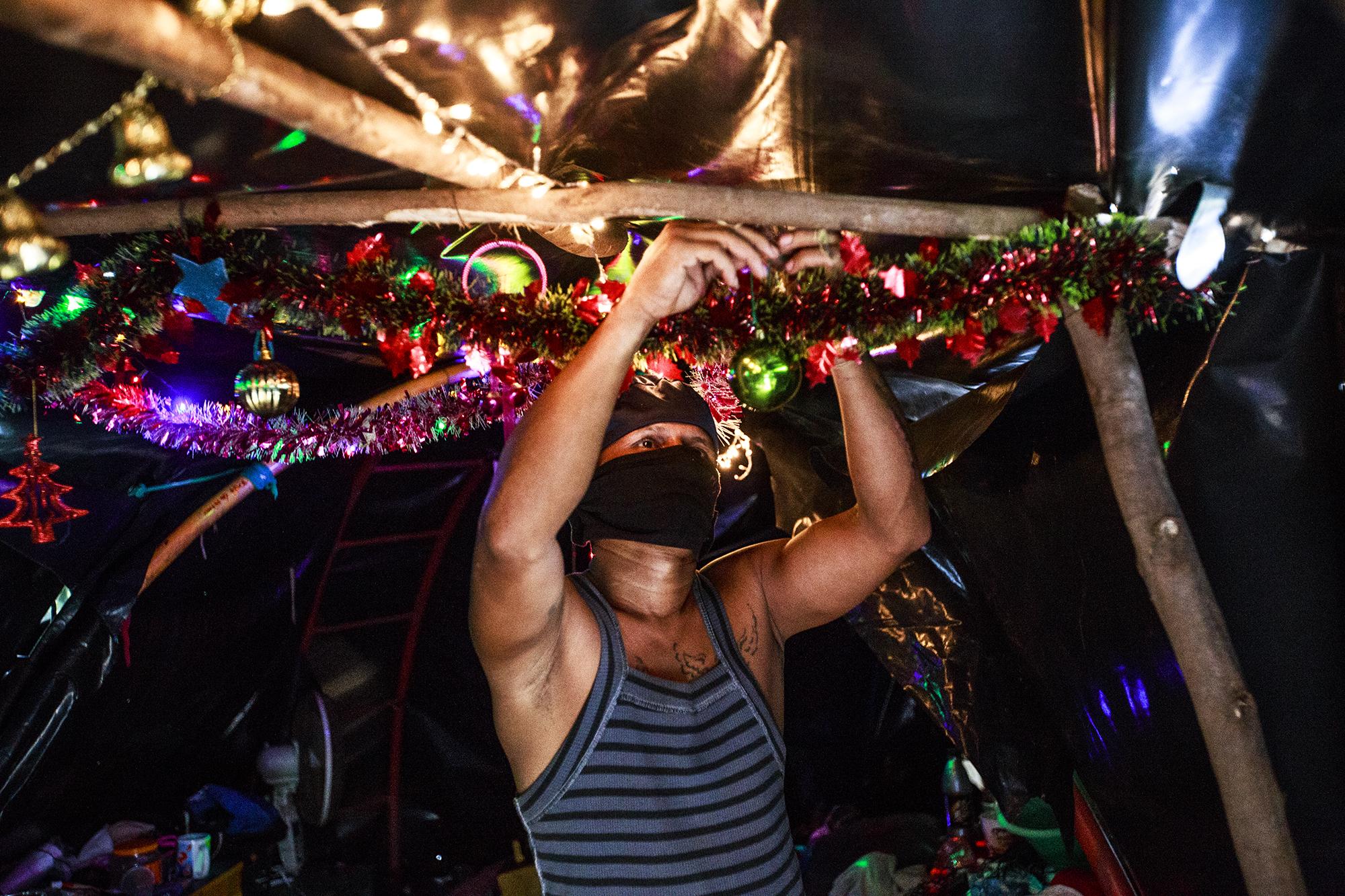 A student hangs Christmas decorations in his tent on campus grounds. Many of the students stayed here since the protests began. Some have been identified by police forces and fear for their lives. June 27, 2018.