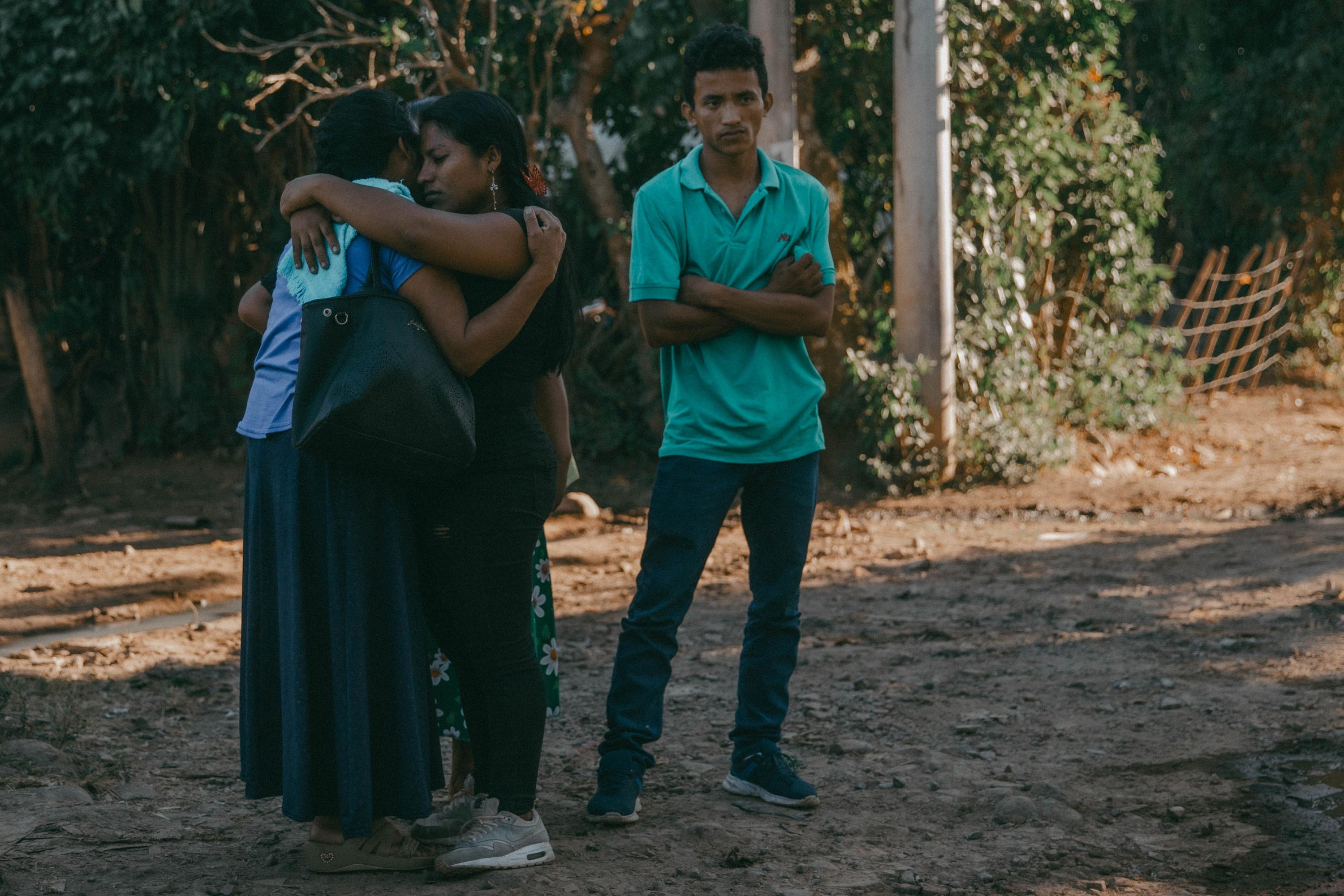 Virginia cries as she hugs two of her children, Melvin and Delmy, on December 14, 2023, after learning that the Ilobasco Rehabilitation Farm had postponed Samuel’s release.