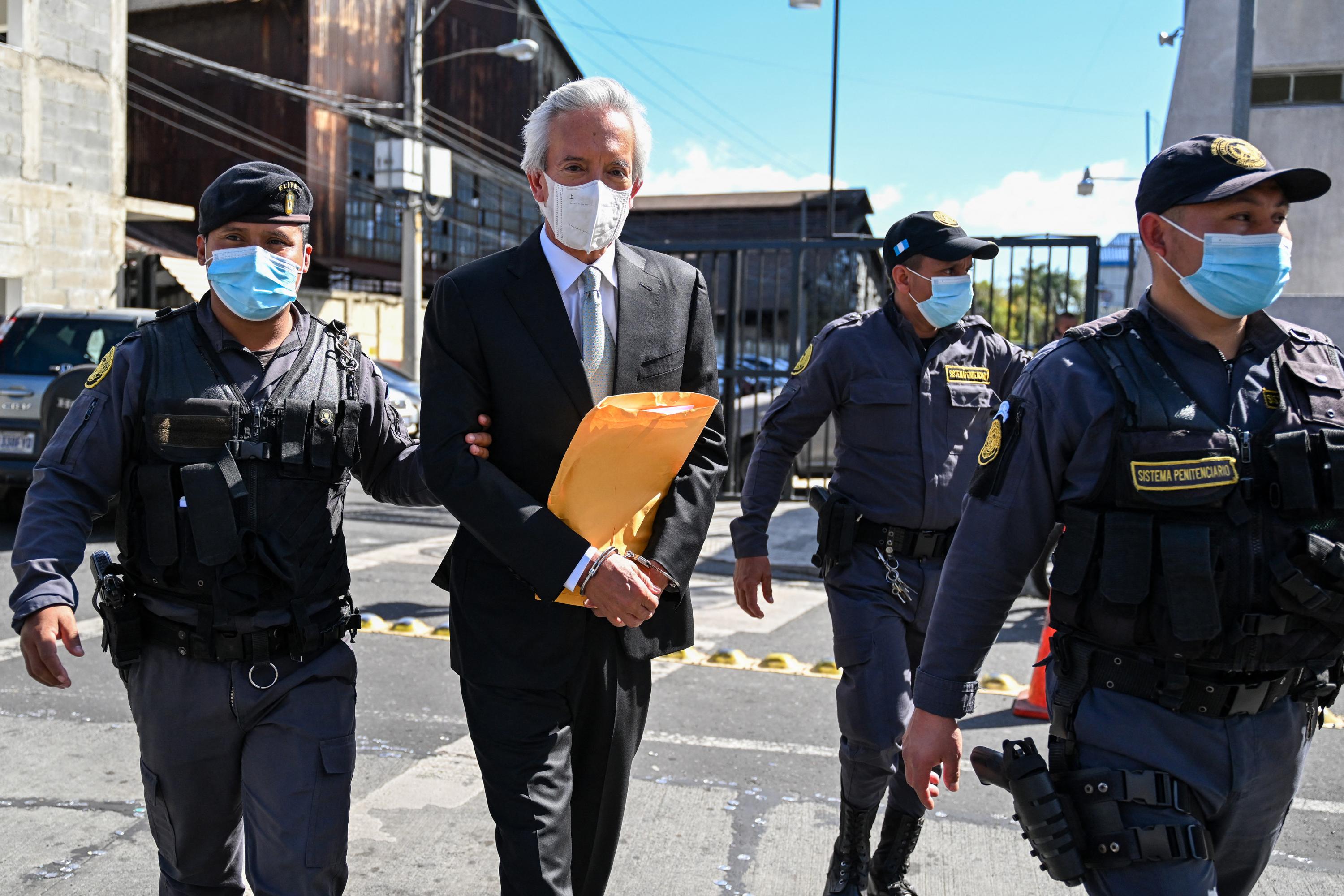 El periodista guatemalteco José Rubén Zamora, presidente de El Periódico, es escoltado por la policía fuera de la corte en la Ciudad de Guatemala, el 31 de enero de 2023. Foto de El Faro: AFP/Johan Ordóñez