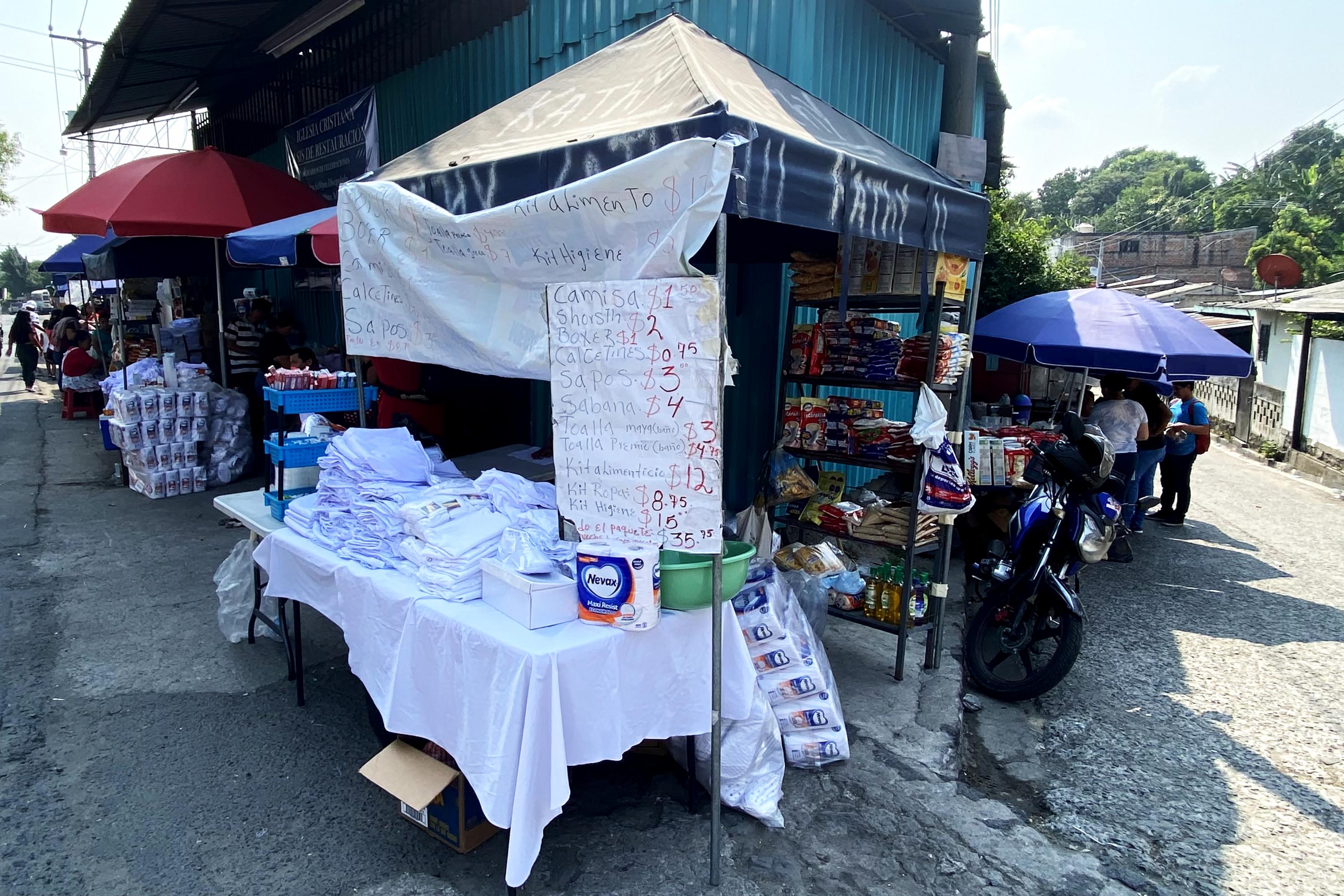 Ever since the army and police used tanks to evict the original family members and businesses in front of Mariona Prison, new businesses have set up outside the prison gates. Photo Carlos Martínez