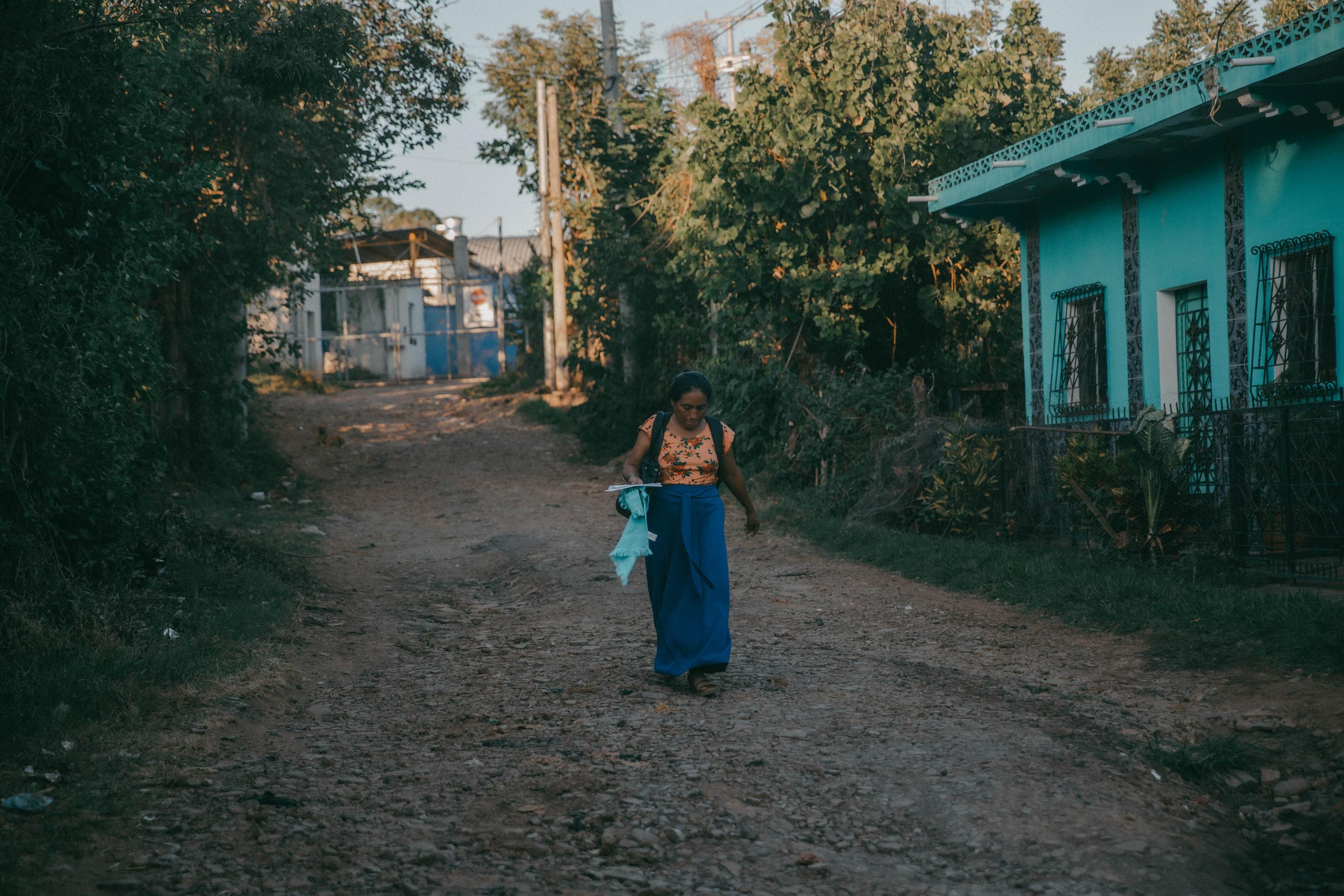 On December 13, 2023, Virginia Cali, 50 years old, walks past the entrance of the Ilobasco Rehabilitation Farm after inquiring about the process to release her son, Samuel, who had been acquitted of illicit association. That day, and the next, Virginia left without her son as a result of bureaucratic delays. It would take nearly two more months before Samuel was finally released.