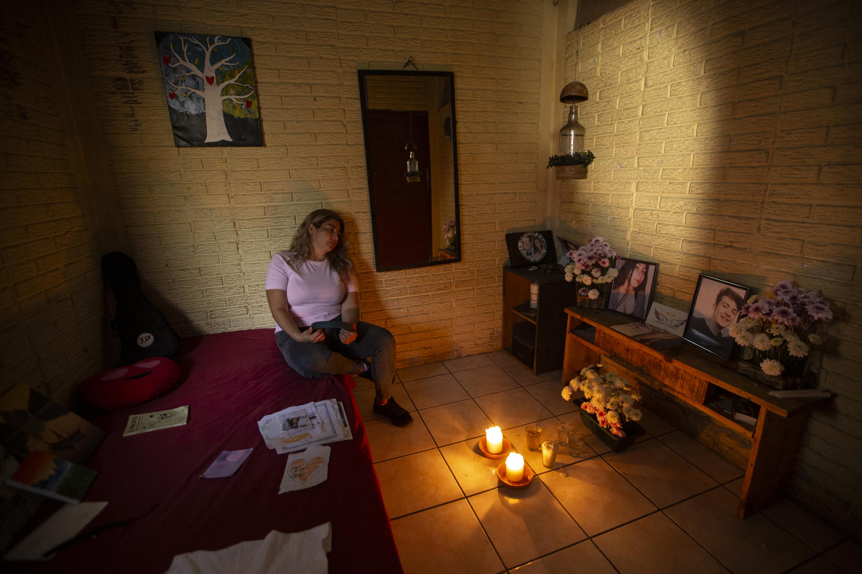 On Sep. 18, 2021, Ivette’s two children, Karen and Eduardo Guerrero, were kidnapped in the Quezaltepec neighborhood of Santa Tecla. She searched for 98 days until their bodies were found on December 23 in a clandestine cemetery in the neighboring municipality of Nuevo Cuscatlán. The case was widely covered by the media. “Officials do not consider the harm they cause,” Ivette says. “For many, my children died because they were gang members and drug traffickers, because that’s the message from the government and from [Security Minister] Gustavo Villatoro.” She says the government politicized her case, which is why she decided not to pursue it with a defense lawyer. She only knows what the prosecutors tell her, because the Attorney General’s Office has declared the case confidential. Ivette, pictured here gazing at an altar in her children’s bedroom, fled El Salvador a few months ago and prefers not to name the country that granted her asylum, where she works in a public hospital kitchen. “After I found my children, the government backed me into a corner. I was not safe anywhere,” she says. “I felt something might happen to me, and not from the gang members who controlled my neighborhood, but because of the attacks from the government to tarnish their image. At least I’m not living in fear anymore. But coming here doesn’t fix my life. It’s hard to survive here too.” Photo by Víctor Peña.