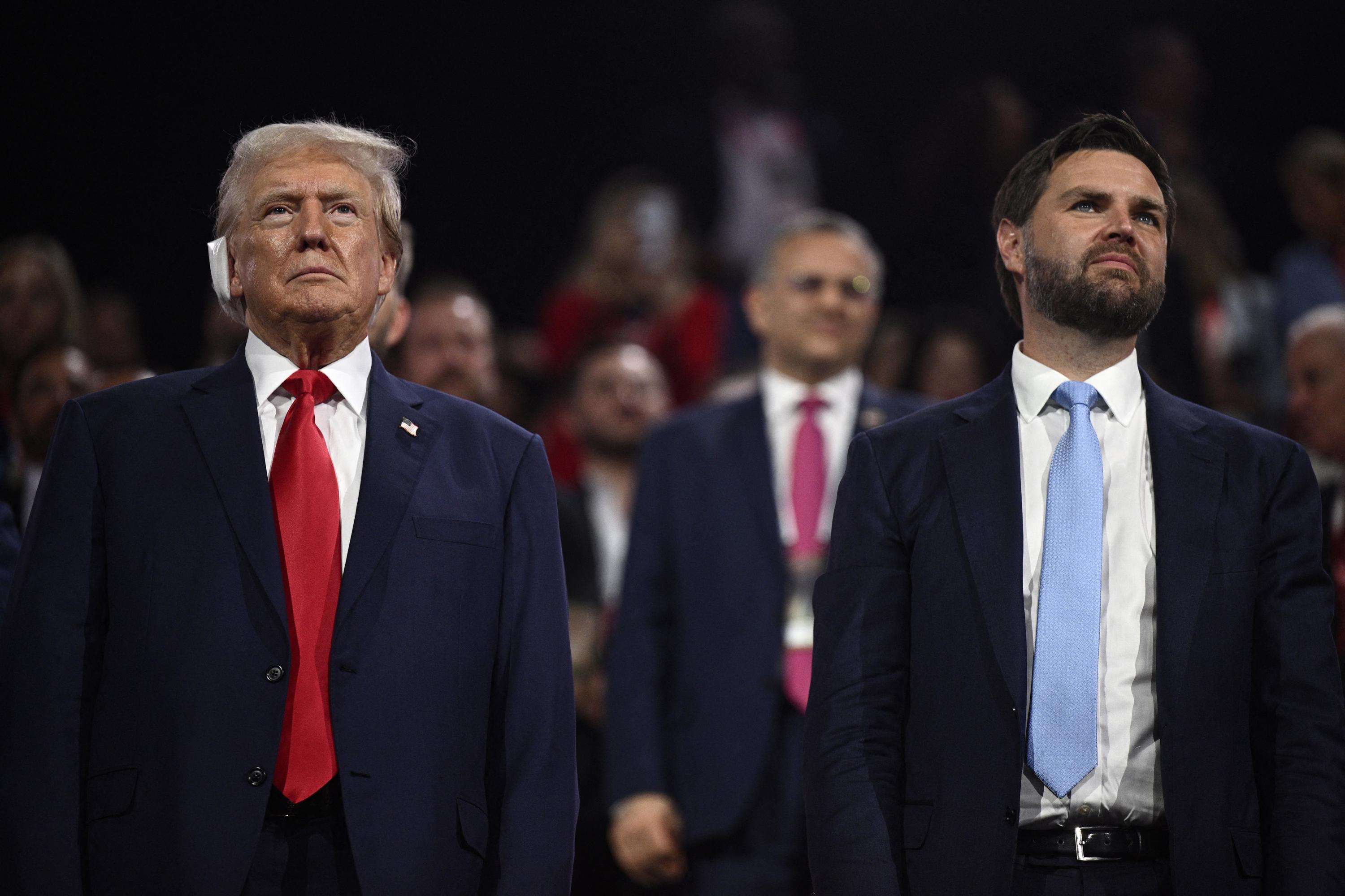 Former U.S. president and 2024 Republican presidential candidate Donald Trump (left) stands with his loyalist running-mate, Ohio Senator J. D. Vance, during the first day of the 2024 Republican National Convention at the Fiserv Forum in Milwaukee, Wisconsin, July 15, 2024, kicking off a triumphalist party convention in the wake of what the FBI is investigating as a failed assassination attempt. Photo Brendan Smialowski/AFP