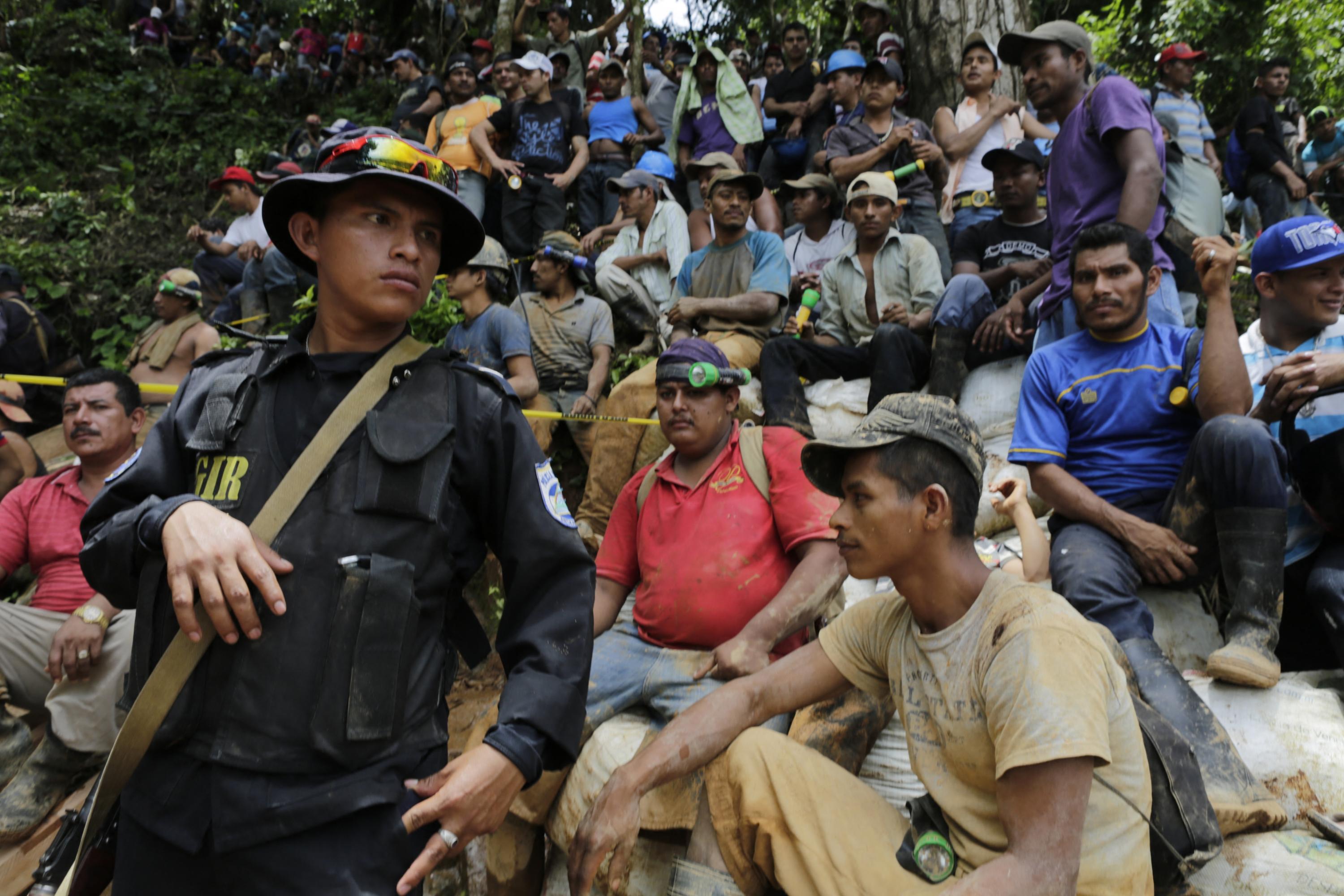 Relatives, friends, and fellow miners wait as rescuers try to reach a group of miners trapped in a gold mine in the community of El Comal, near Bonanza in northeastern Nicaragua, on Aug. 29, 2014. At least 20 miners were trapped alive deep underground after an informal gold mine collapsed in northeastern Nicaragua, stated presidential spokeswoman Rosario Murillo. “We have identified 20 comrades who are alive,” Murillo said, adding there were 28 miners working in the shaft 800 meters (2,600 feet) underground when the cave-in happened. Two miners had managed to dig their way out. Photo Inti Ocon/AFP