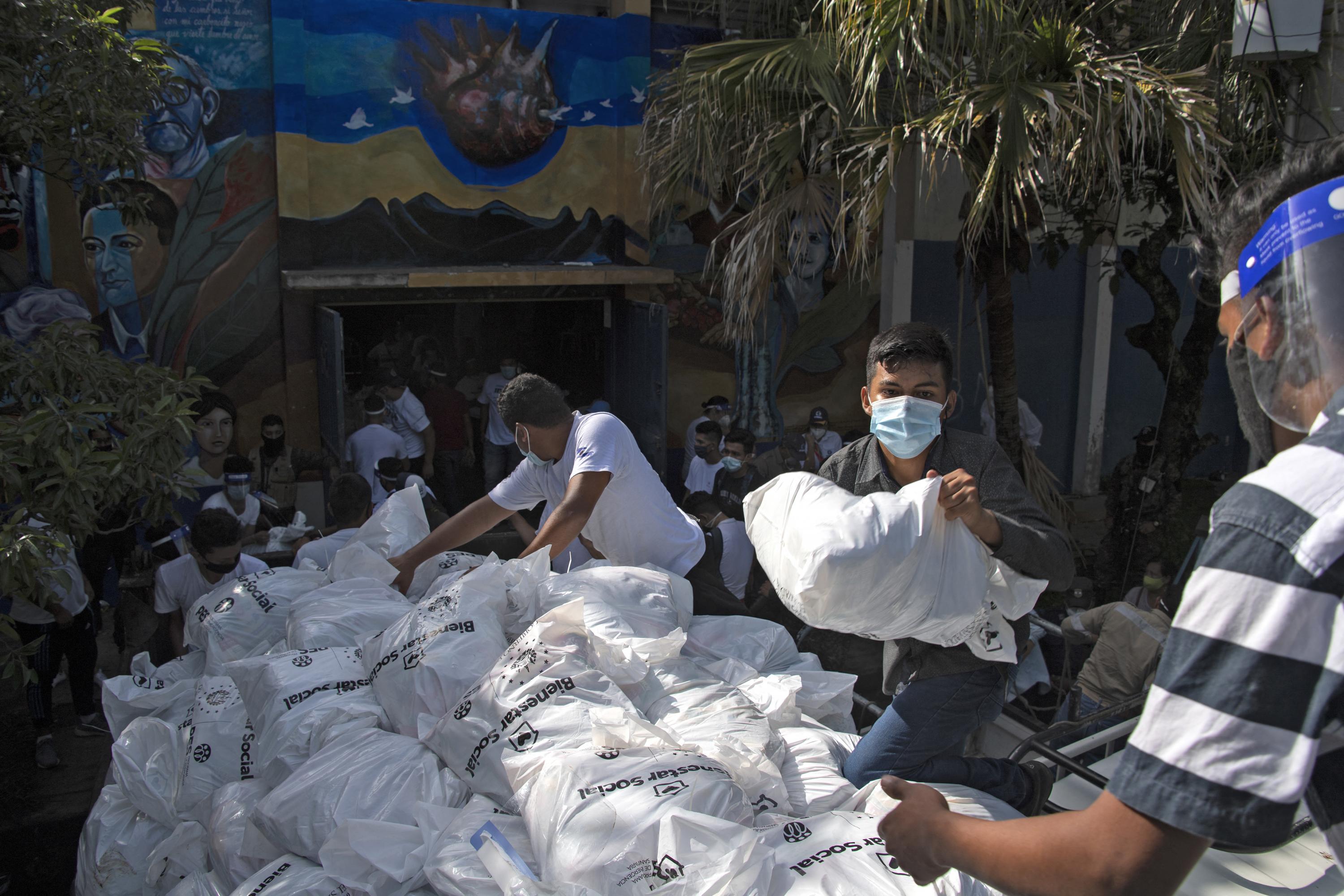 Volunteers from the National Institute for Youth (INJUVE) prepare to distribute pandemic relief bags at a municipal facility in Santa Ana, El Salvador, on July 1, 2020. Photo Yuri Cortez/AFP