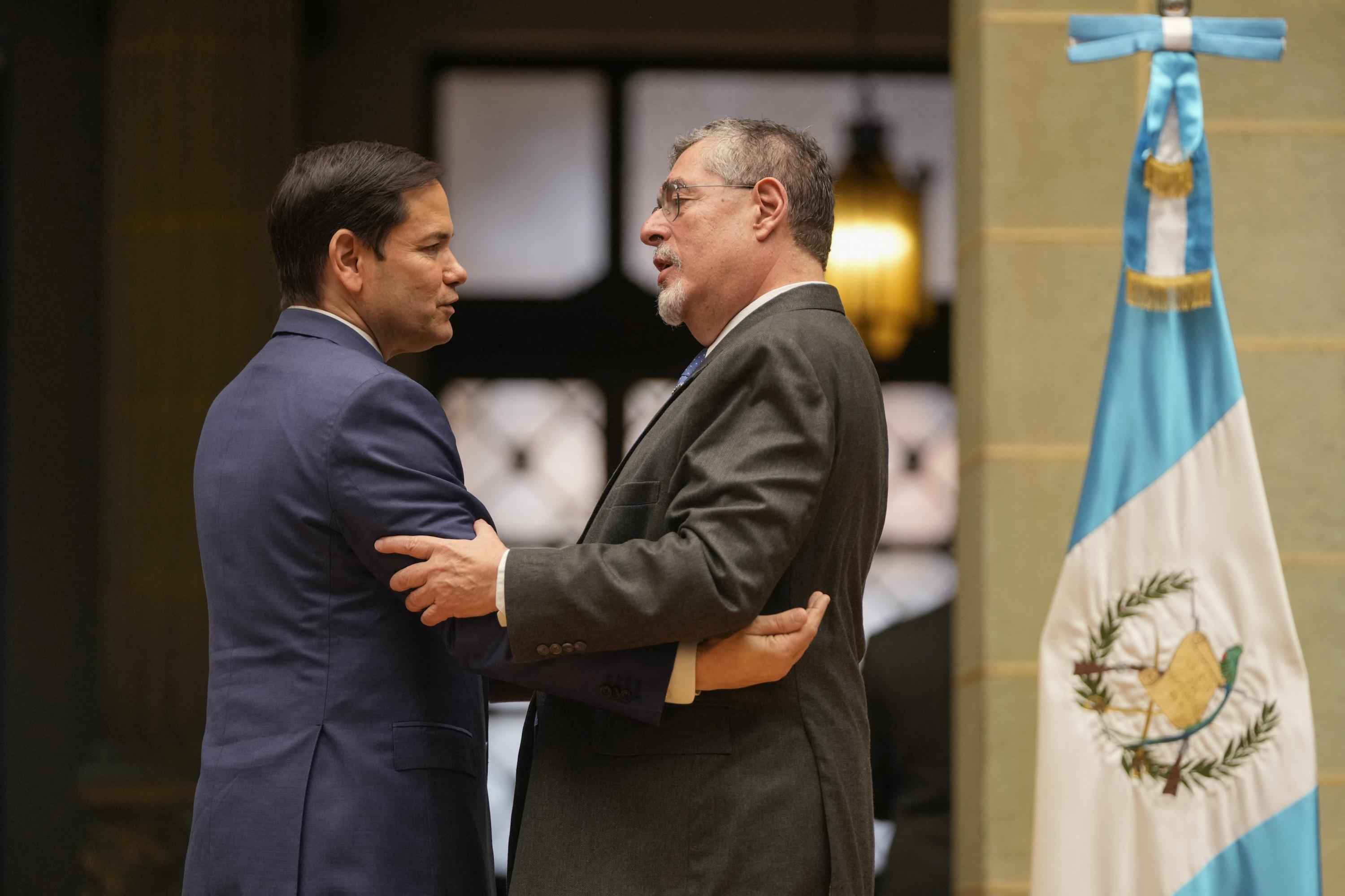 U.S. Secretary of State Marco Rubio (left) embraces Guatemalan President Bernardo Arevalo after a joint news conference at the National Palace of Culture in Guatemala City on Feb. 5, 2025. Arévalo announced that Guatemala will receive 40 percent more deportation flights, while Rubio said that the U.S. Army Corps of Engineers will support the construction of new port infrastructure and other projects. Photo Mark Schiefelbein/Pool/AFP