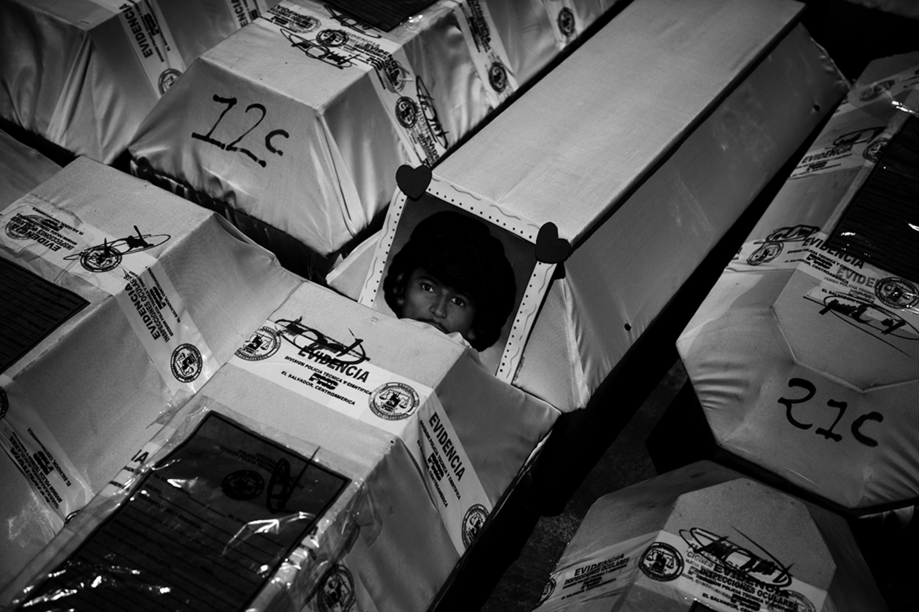 A coffin without police evidence ribbons shows the portrait of Miguel de Jesús Mata, a local farmer who was murdered at the age of 24 in the hamlet of Costa Rica, Texistepeque, on Nov. 20, 1982. Seven men died in that place at the hands of the military, who, with list in hand, took each of them out of their homes, tortured, and killed them. Mata was identified by his family, who kept the remains in their home until they decided to bury them with the other victims in solidarity with the other families.