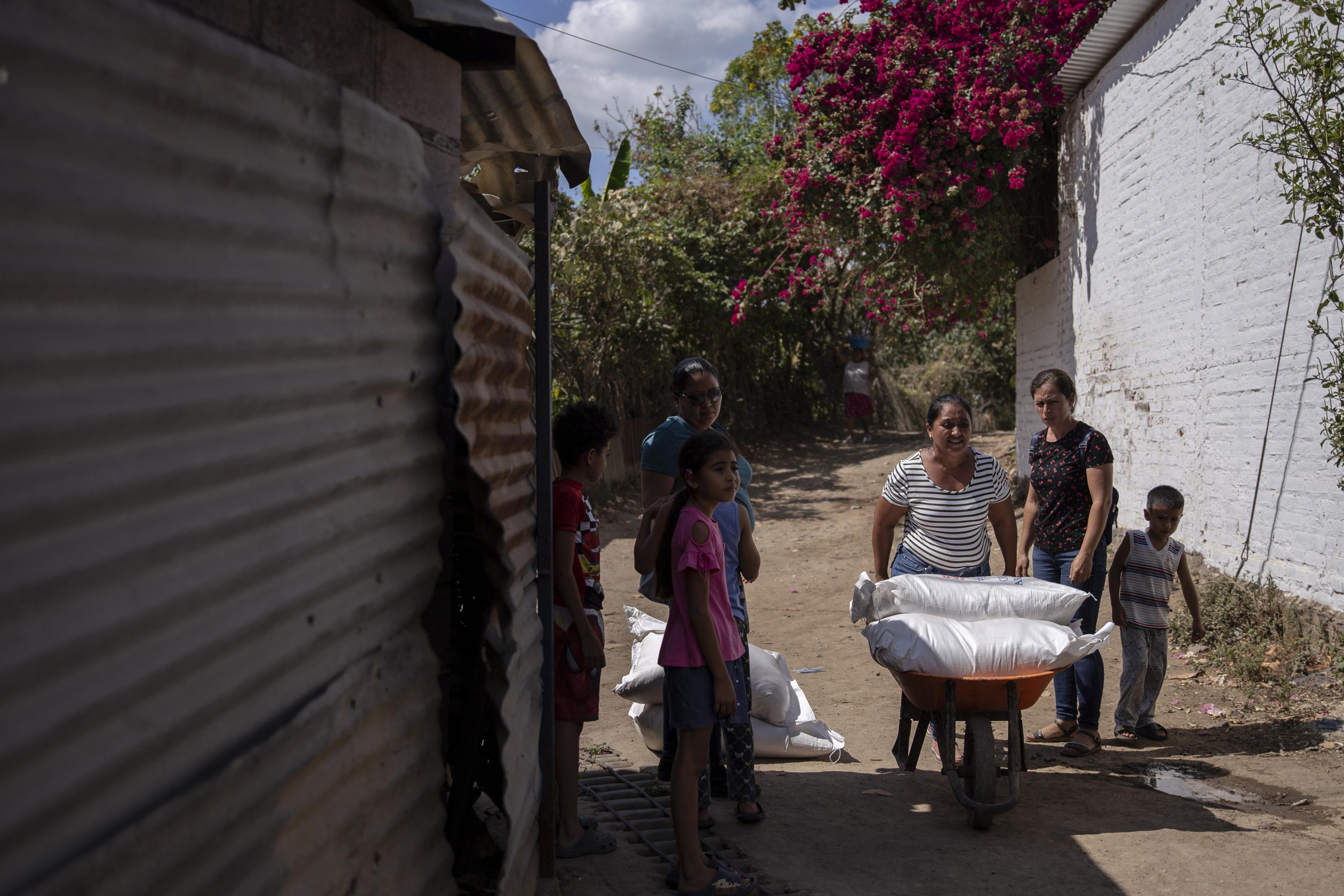 Habitantes del cantón El Tinteral trasladan los sacos de arroz hasta sus casas. Ellos llegaron hasta la Segunda Brigada de Infantería de Santa Ana para retirar la donación y trnasportarla hasta esa zona rural del municipio de Coatepeque, el viernes 19 de enero. 