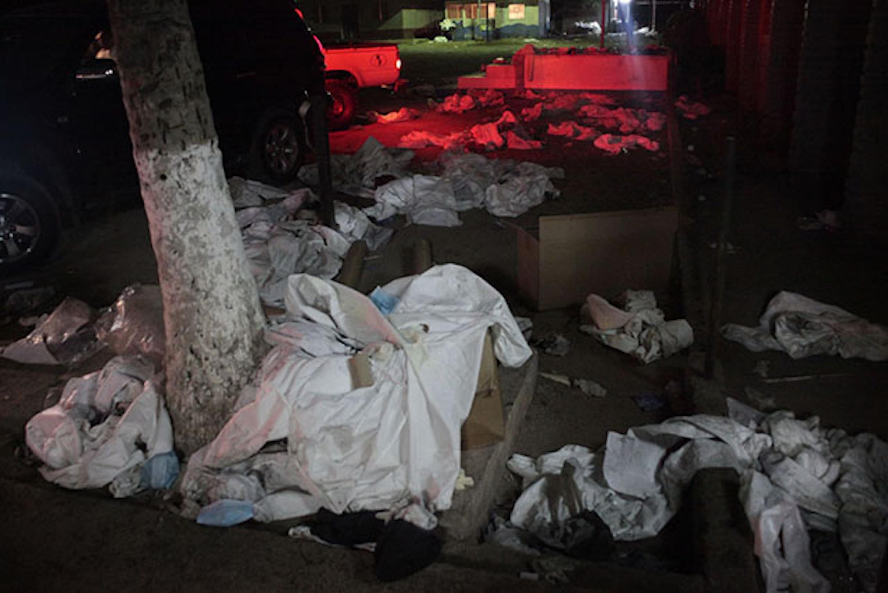 Piles of sheets are strewn outside Comayagua prison in Honduras. The sheets were used by forensic experts to remove the remains of over 350 people who died in a fire at the facility on February 15, 2012. Photo from the El Faro archive.