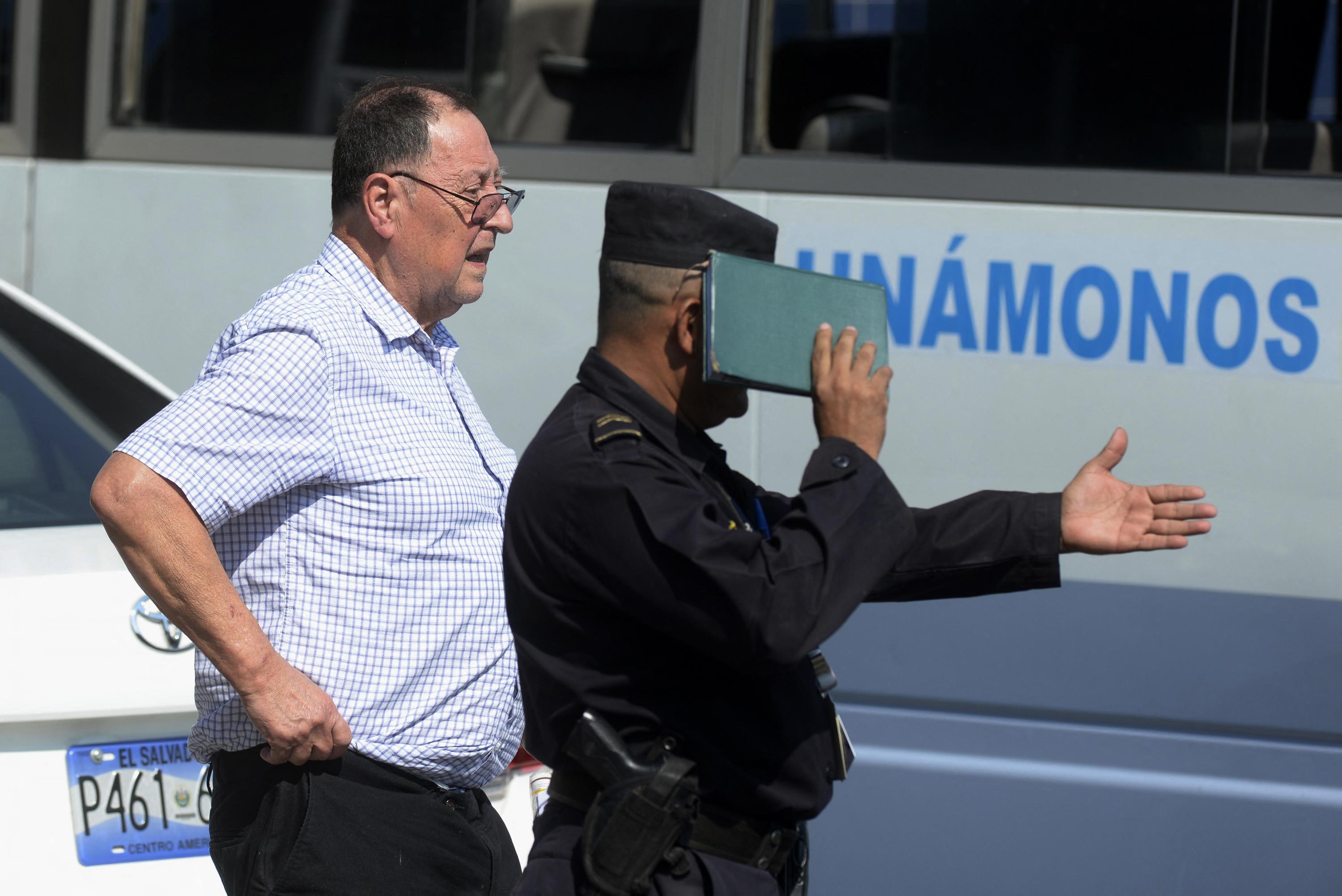 Former Salvadoran Defense Minister Eugenio Vides Casanova (1983-1989) is escorted by authorities upon his arrival to the Monsignor Óscar Romero International Airport on Apr. 18, 2015, following his deportation from the United States for having committed grave human rights abuses, including torture and extrajudicial killings, during the Salvadoran civil war. Photo Marvin Recinos/AFP