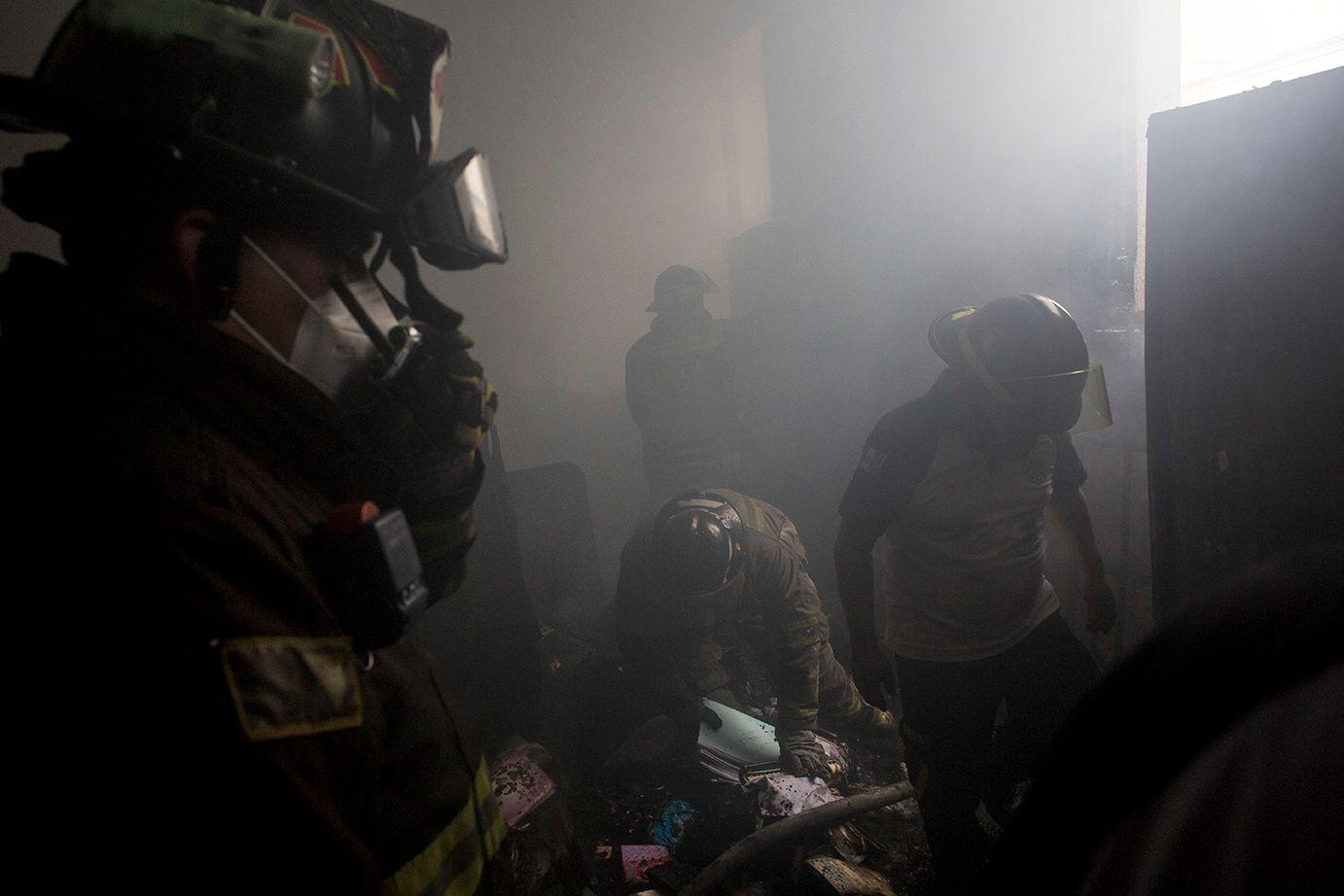 Volunteer firefighters put out the fire inside the Congress, trying to rescue the remains of documents and official records kept in the damaged rooms /