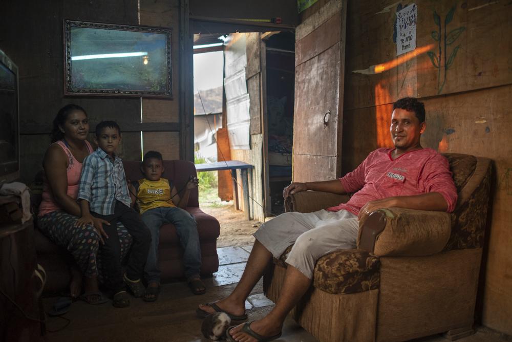 The Viera family inside their home. Oscar Viera collects and sells scrap metal to support his family. The Vieras also have a homemade mud stove outside their home which they allow neighbors to use.