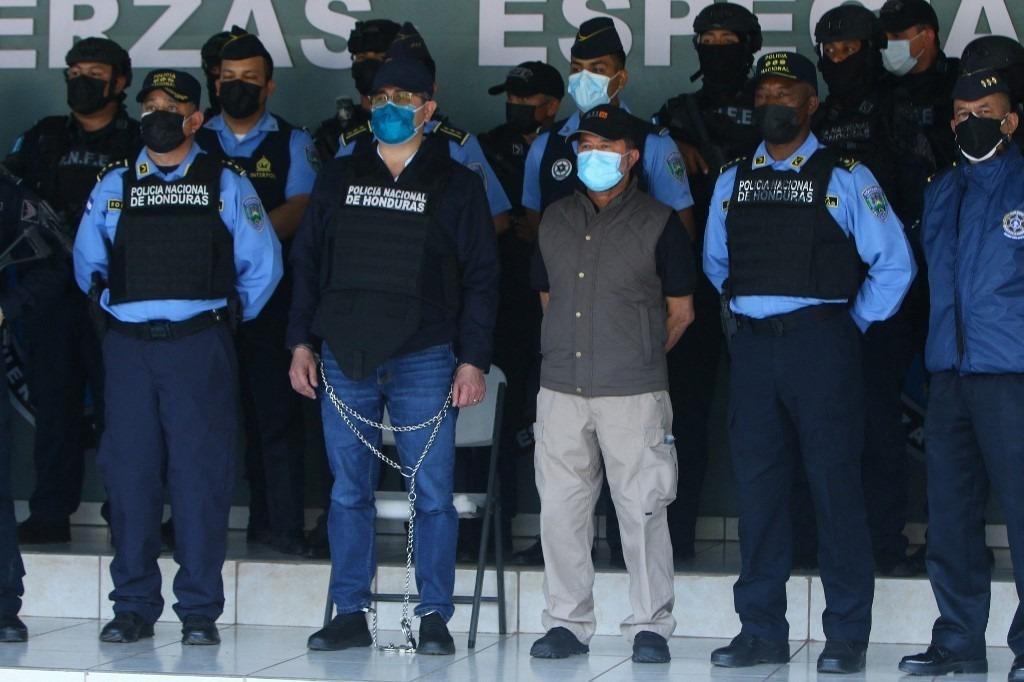 Former president Juan Orlando Hernández with the Honduran National Police following his arrest on Feb. 15, 2022. Photo: AFP