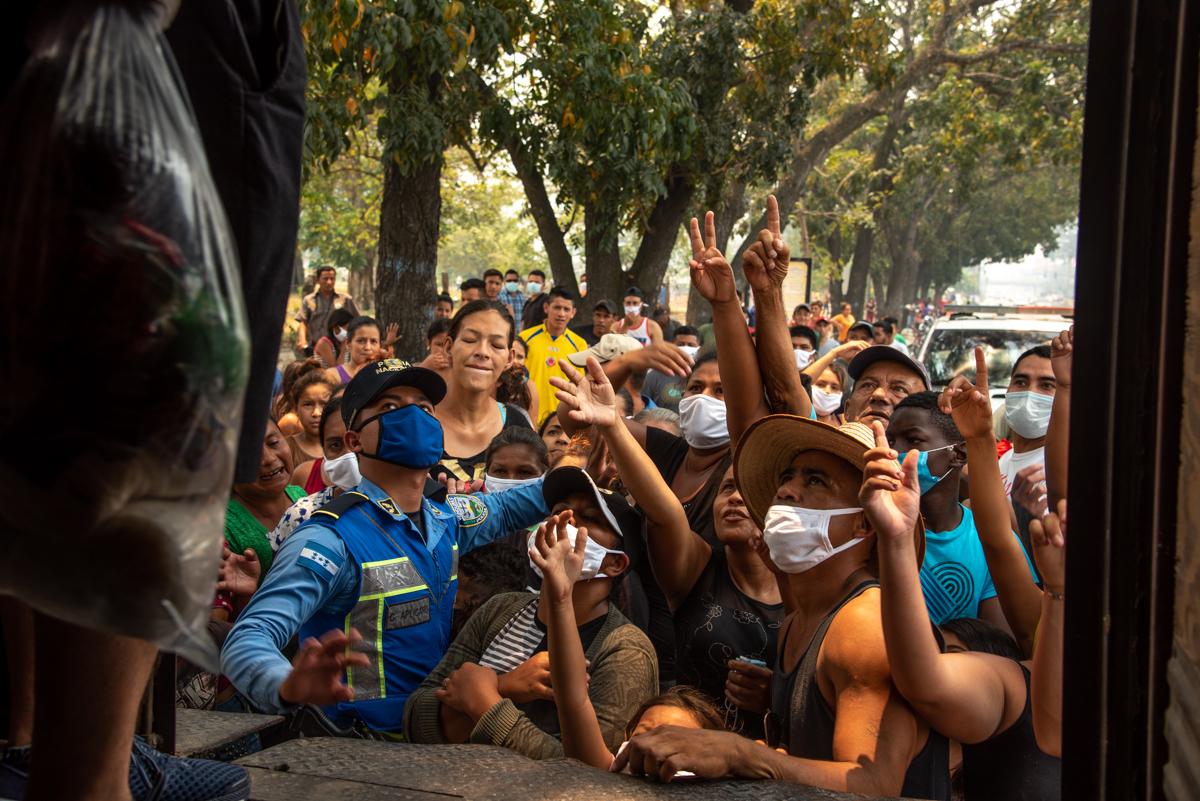 Citizens in need get upset after a local charity runs out of bags of essential food. San Pedro Sula. April, 17th, 2020. Photo: Seth Berry