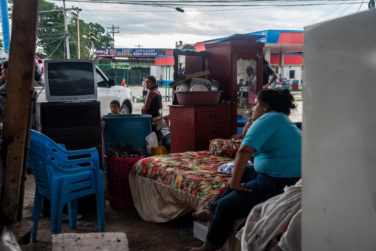 A displaced woman with all of her belongings sits underneath an overpass in San Pedro Sula, Honduras. Without enough shelters, many have had to seek refuge in makeshift camps underneath overpasses in the area of Calpules and Chemelecon.