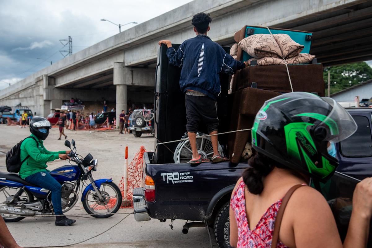 People evacuate on the day of major flooding, leaving the lower San Pedro Sula Valley in Honduras to seek shelter elsewhere.