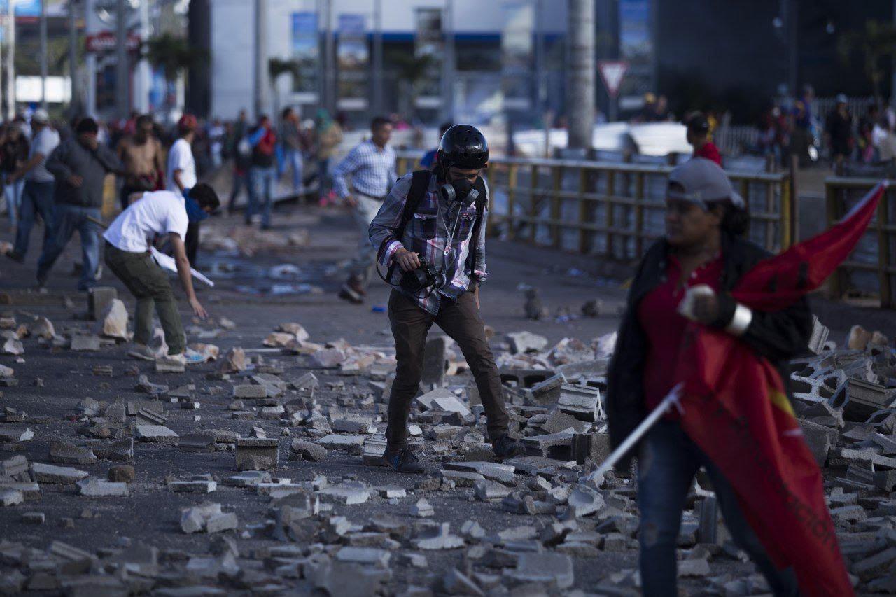 Photojournalist Martín Cálix finds himself the subject of a picture during a protest in Tegucigalpa, Honduras. 