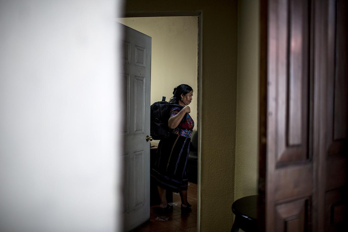 Vicenda Jerónimo picks up her backpack in her office, ready to go back to her community. Photo by: Simone Dalmasso