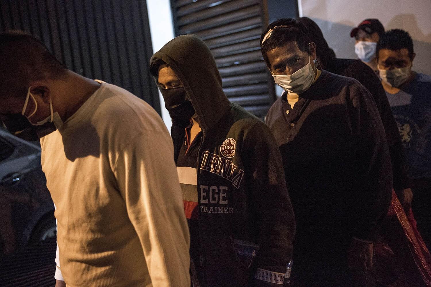 Caption: Guatemalan migrants deported from Houston, Texas wait in line to board a bus with a group of 74 others on Monday, May 4, 2020. Photo: Oliver de Ros