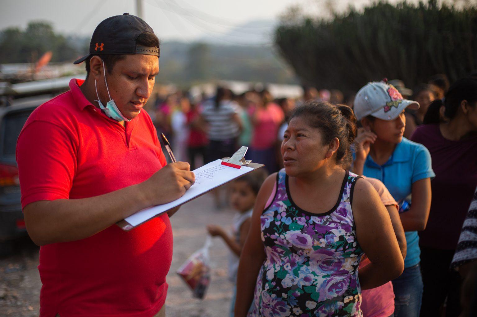 Dozens of women stand in line to receive food rations from the soccer fan club Ultra Fiel as part of a community service activity. Lepaterique, April 19, 2020. Photo by: Martín Cálix.