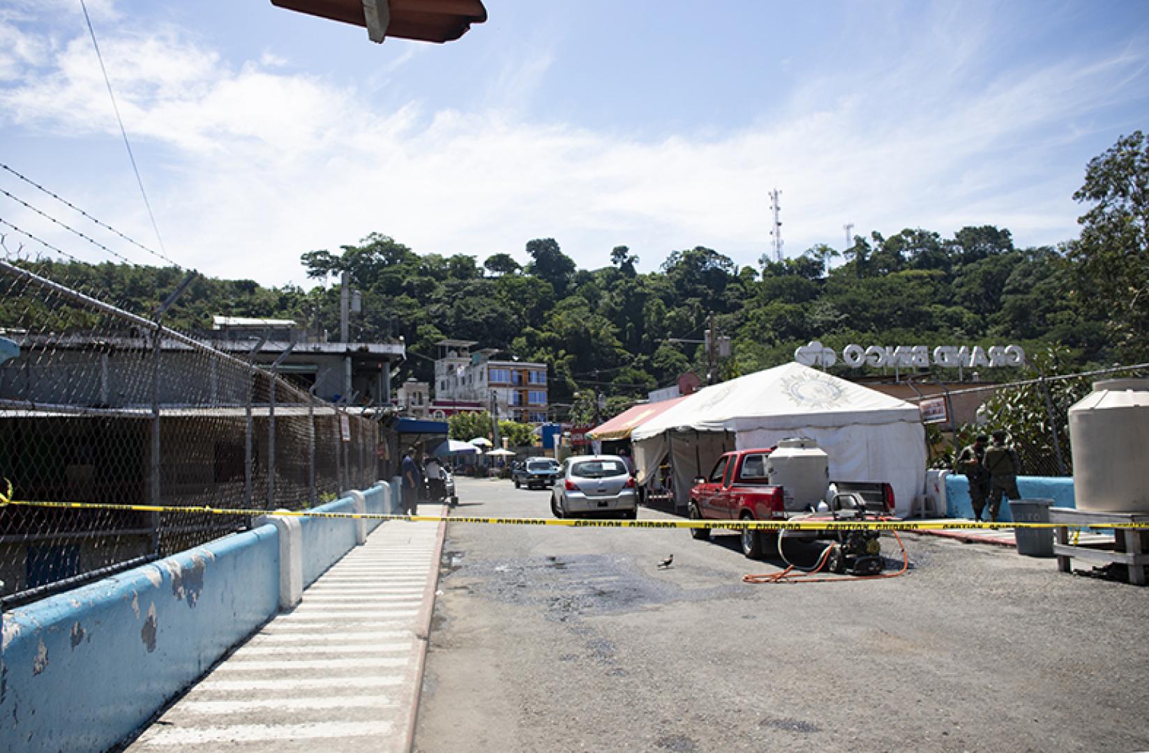 Guatemalan soldiers guard the border crossing, only allowing their citizens to enter after going through an interrogation and disinfecting their cars.