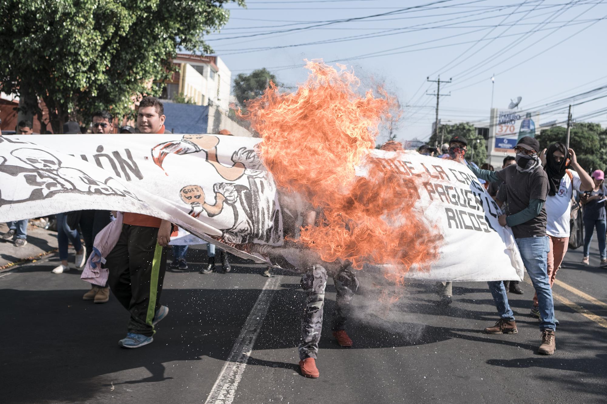 Un manifestante lanza llamas durante la marcha en contra de la conformación del ente rector del agua. La marcha salió desde la Universidad de El Salvador y se dirigió hasta la Asamblea Legislativa. Foto: Fred Ramos