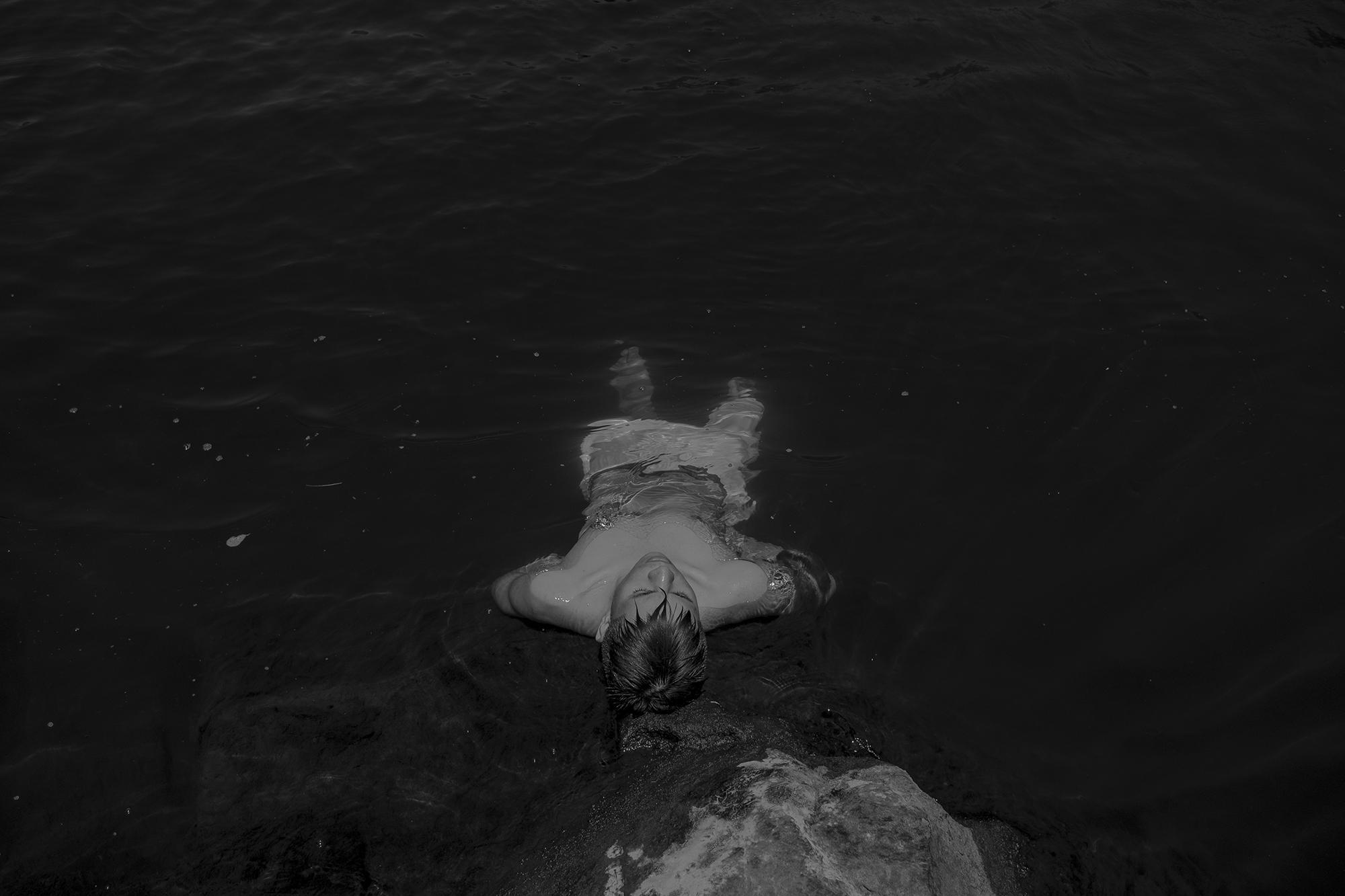 A young man from Santa Marta bathes in the Lempa River, cooling off after the long anniversary walk. An estimated 200 people died in this river during the massacre. Today, these acts of remembrance also serve as a kind of paseo, or social outing, for members of the community.