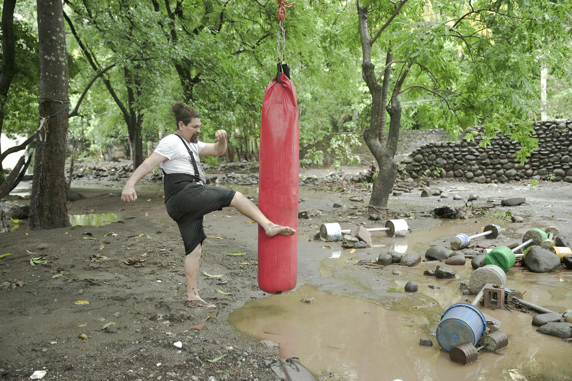 Jaime Abarca strikes a punching bag in what is left of his tiny at-home gym in the Río Grande community of Tamanique, La Libertad. Jaime’s home flooded during Tropical Storm Amanda. Photo: Carlos Barrera/El Faro