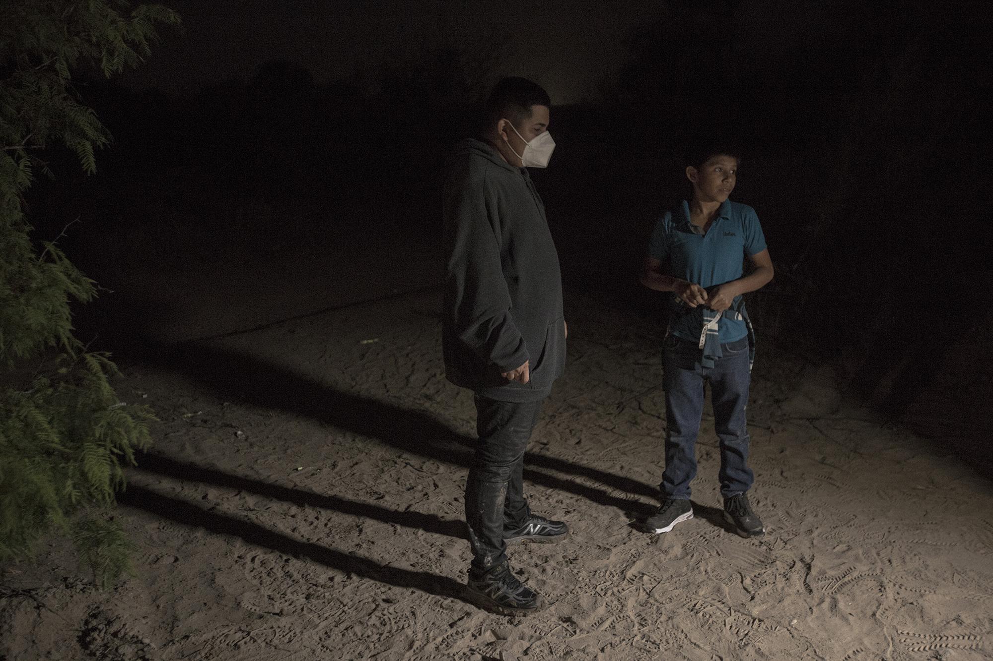 Joan José Diego (left), 17, spent 12 days traveling from Zacapa, Guatemala to the U.S. border. He crossed the river alone, hoping to rejoin his mother in Miami. Standing next to him is Óscar Riquelme Hurtado, 12, who had been travelling alone since February 26. Óscar left his home in Nuevo Progreso, a municipality in San Marcos, Guatemala, and traveled to the border with the help of a coyote hired by his uncle in Los Angeles. His uncle had hired the smuggler to bring Óscar’s mother across, but she decided to send the boy alone.