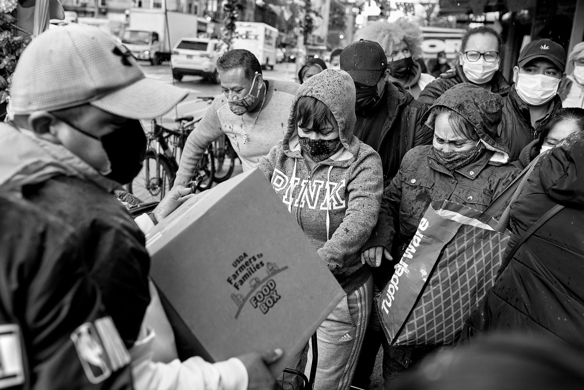 A group of Mexican volunteers distributes boxes of food in the South Bronx. The practice has become common in areas of the city hit hardest by the pandemic and the economic crisis. The distributions are organized by Father Fabián Arias and his network of volunteers. During the pandemic, and still today, migrant mutual aid projects have saved the community from conditions of government neglect. Photo: Edu Ponces/Ruido Photo