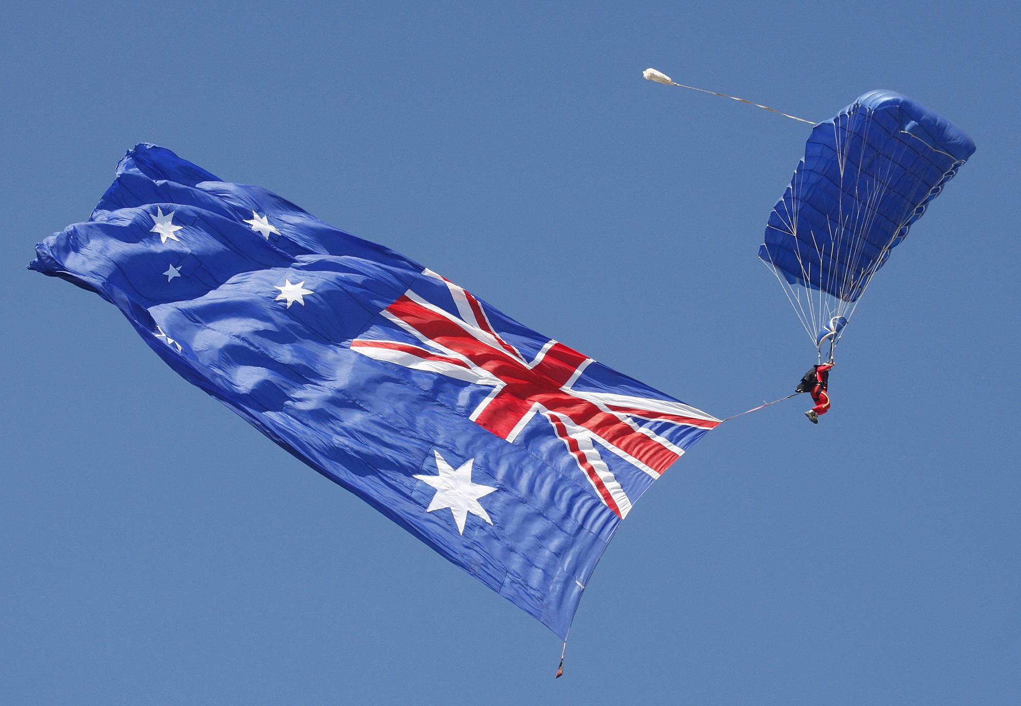 Un paracaidista exhibe una gigantesca bandera de Australia, país que siempre ha mantenido con Estados Unidos buenas relaciones. Foto Tony Ashby (AFP).