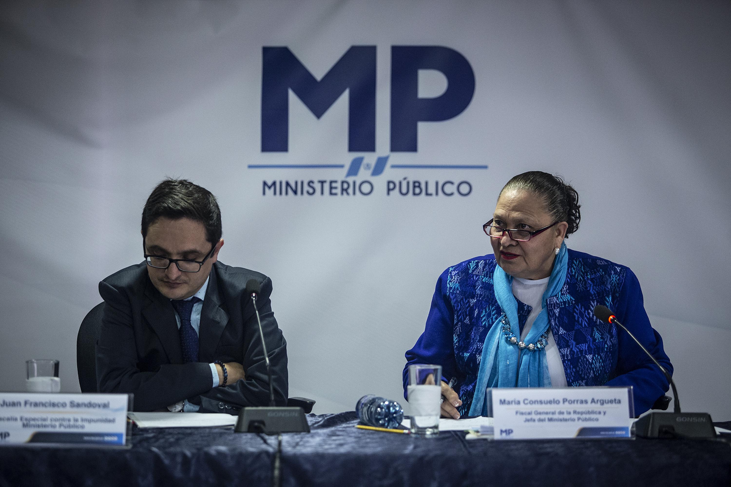 Former FECI chief Juan Francisco Sandoval with Attorney General Consuelo Porras in a 2019 press conference, two years before he abandoned Guatemala for exile. At the time of his dismissal in July 2021, his office was investigating evidence of corruption including informatino that Guatemalan President Alejandro Giammattei had negotiated multimillion-dollar bribes from construction firms to finance his 2019 electoral campaign. Photo: Carlos Barrera/El Faro