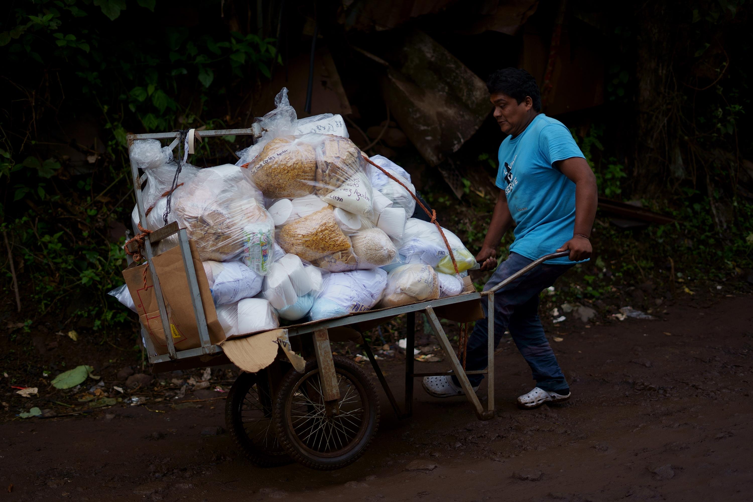 Cristian, 20, has spent the last ten years working at Izalco Prison, transporting packages for family members. His cart can hold 15 bags, and he charges $2.00 per bag, per trip. Before, he was lucky to make one trip a day with a full cart; now he makes three. A boombox attached to his cart plays reggaeton as he walks the two kilometers to the prison entrance. “So my customers don’t get bored,” he says, laughing.