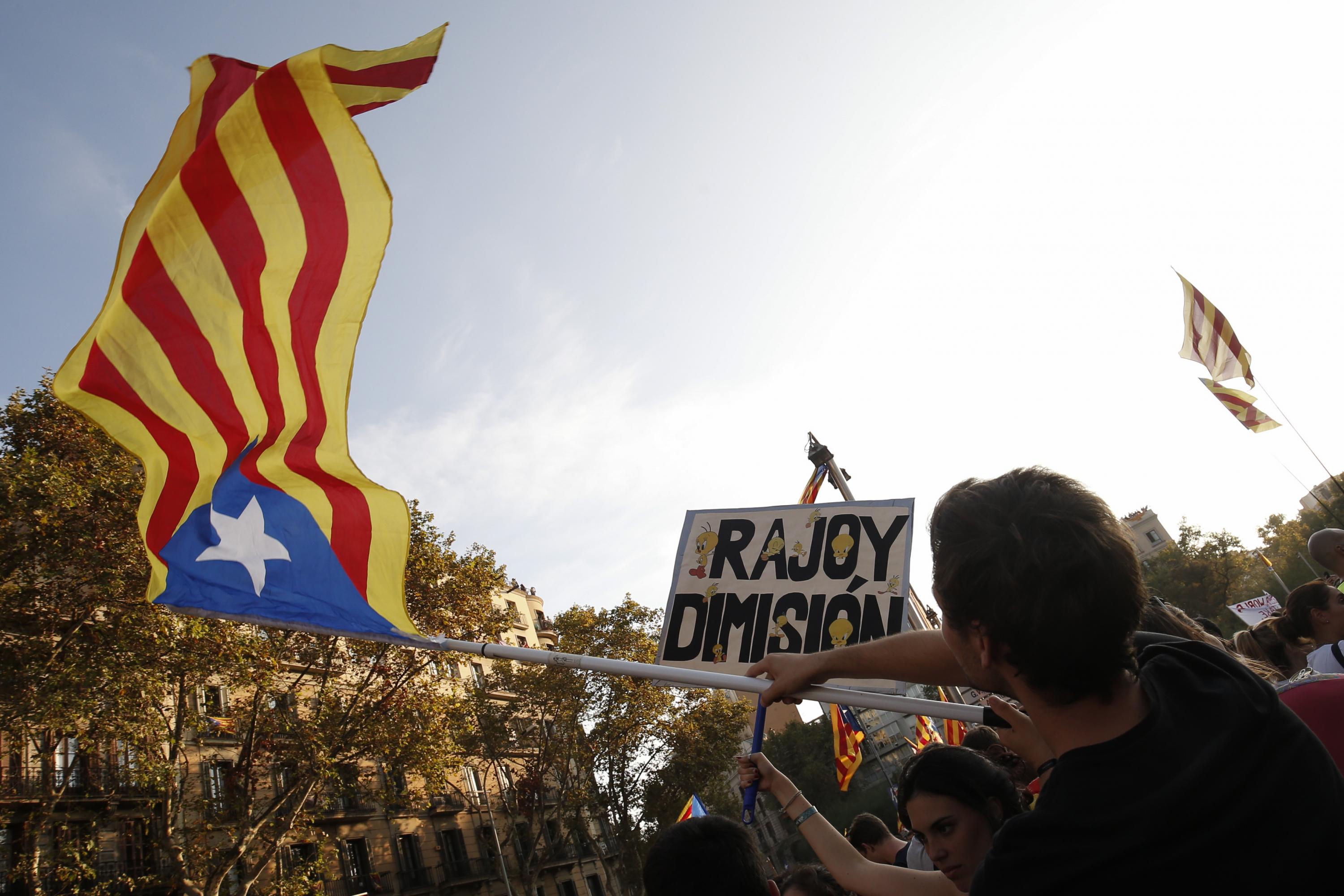 A man holds a Catalan pro-independence 