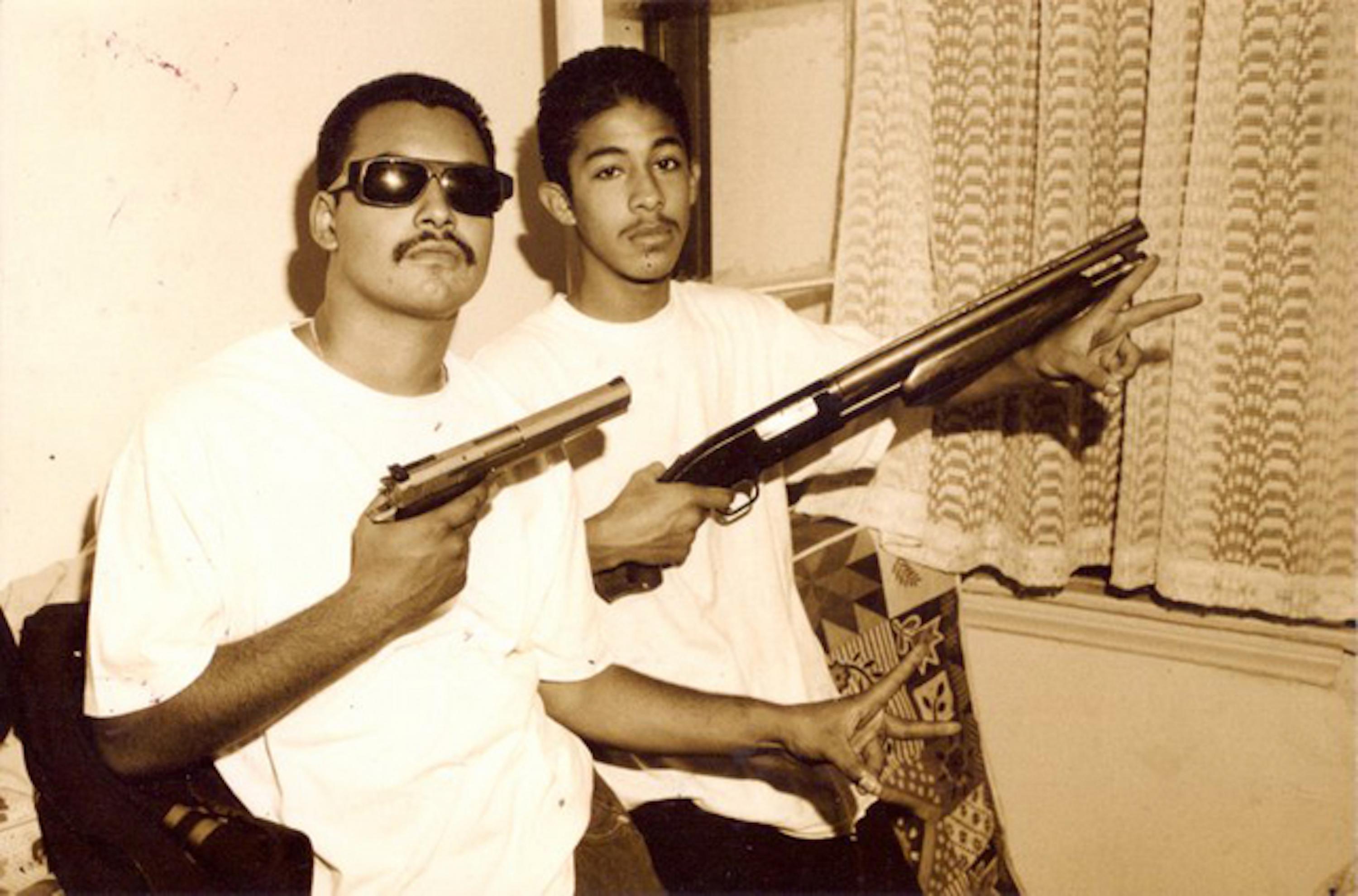 Frosty and Silent, members of the Playboys of Los Angeles gang, flashing their firearms for a photo taken sometime between 1993 and 1995. Photo El Faro archive