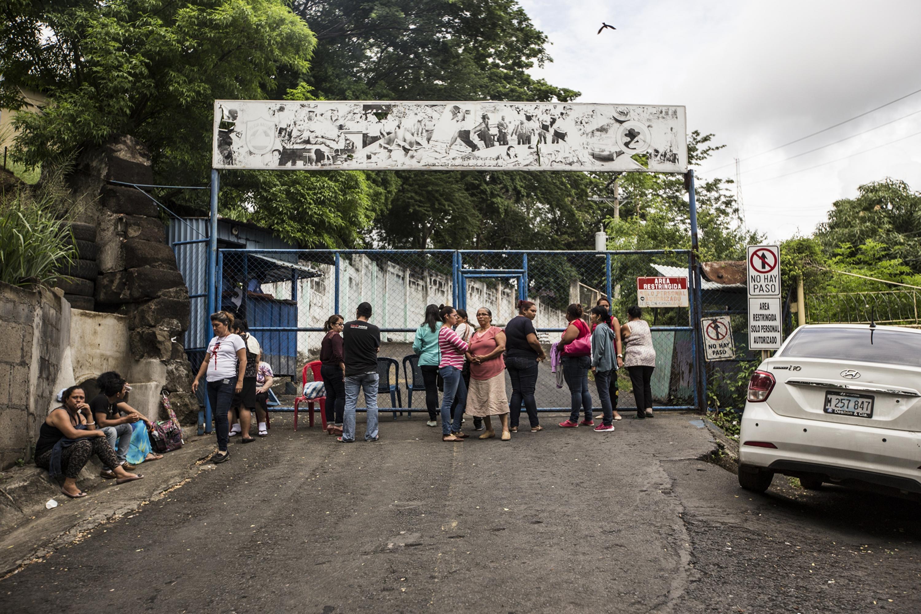 A group of people wait outside El Chipote prison on the afternoon of June 26, 2018, hoping for any information about their detained loved ones. Photo Fred Ramos