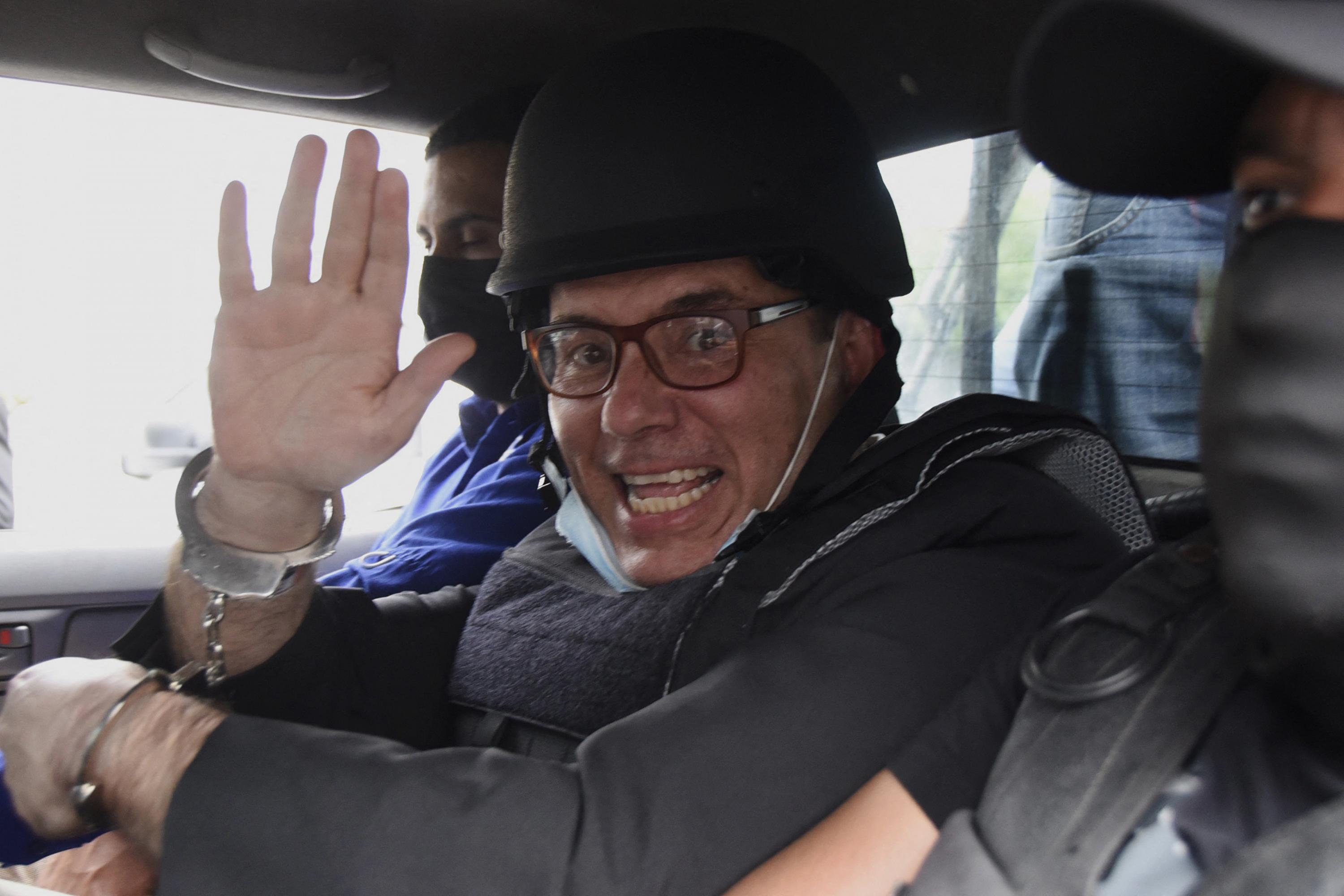 Former Guatemalan presidential candidate Manuel Baldizón waves upon his arrest in Guatemala City on October 5, 2022. Still facing bribery charges in the country