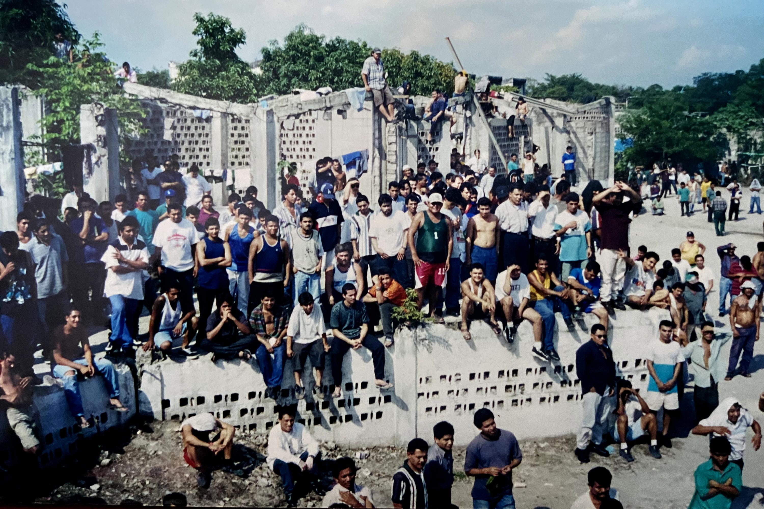 En los 90, Mariona era una prisión en ruinas, gobernada absolutamente por la organización criminal La Raza, liderada por El Brother. Esta fotografía fue tomada durante una reunión general de internos a finales de los 90.