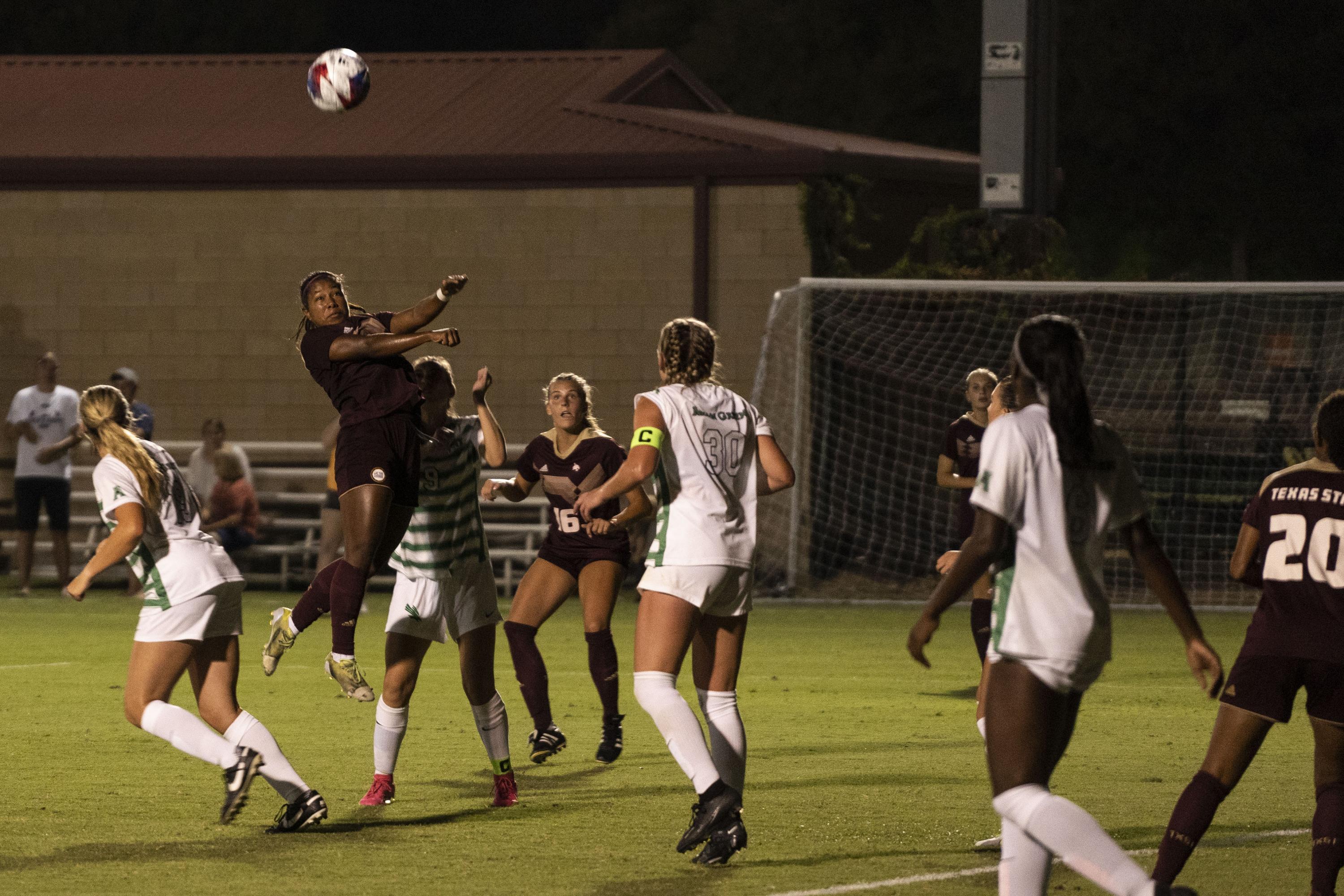 Midfielder Victoria Meza heads the ball during a game against the University of North Texas in San Marcos in August 2023.