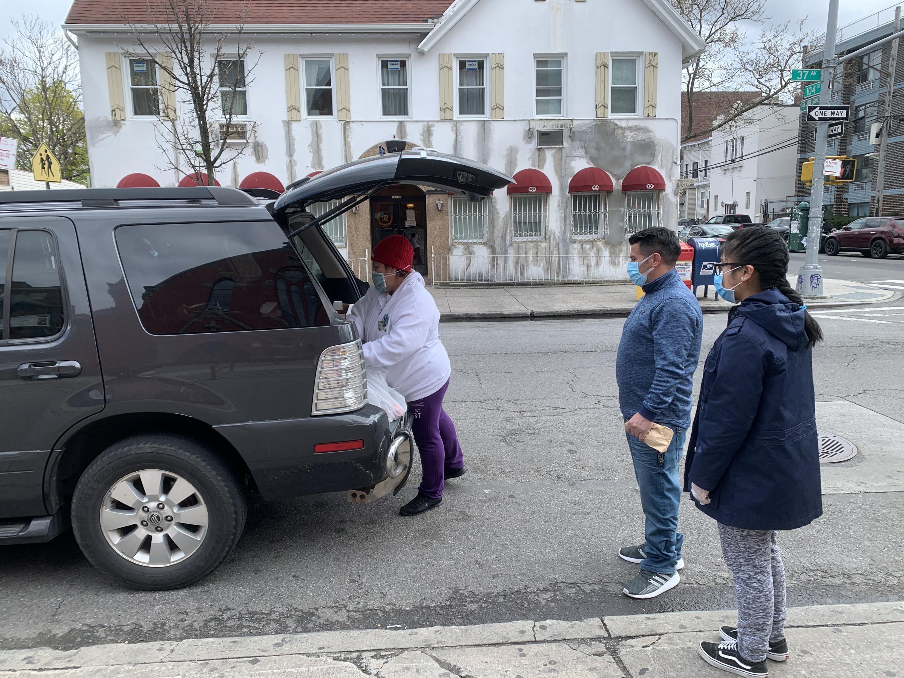Delmy Garcia handing out food from her van.