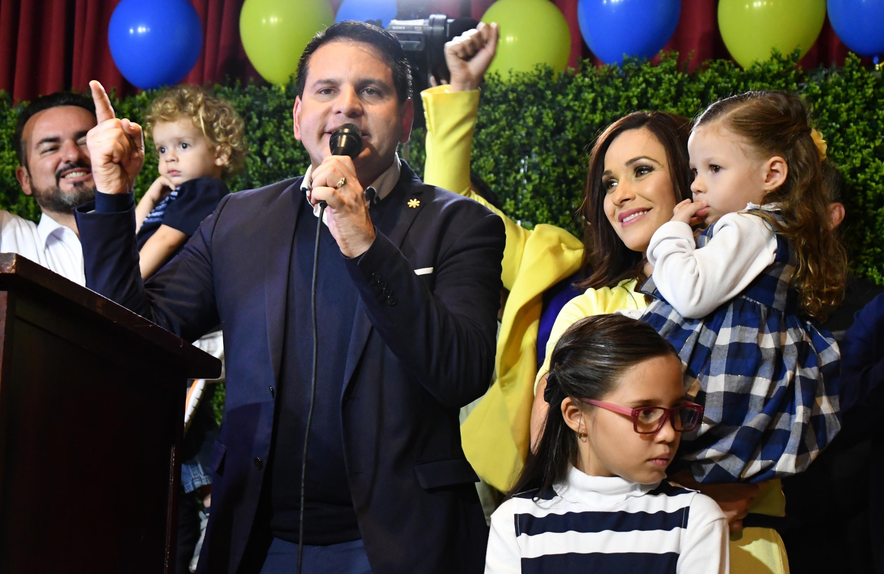 Fabricio Alvarado, candidato presidencial del partido de Restauración Nacional (PRN), saluda a sus seguidores junto a su esposa e hija, en un mitin tras la elección presdencial en San José, Costa Rica. Foto: AFP/ Ezequiel Becerra 