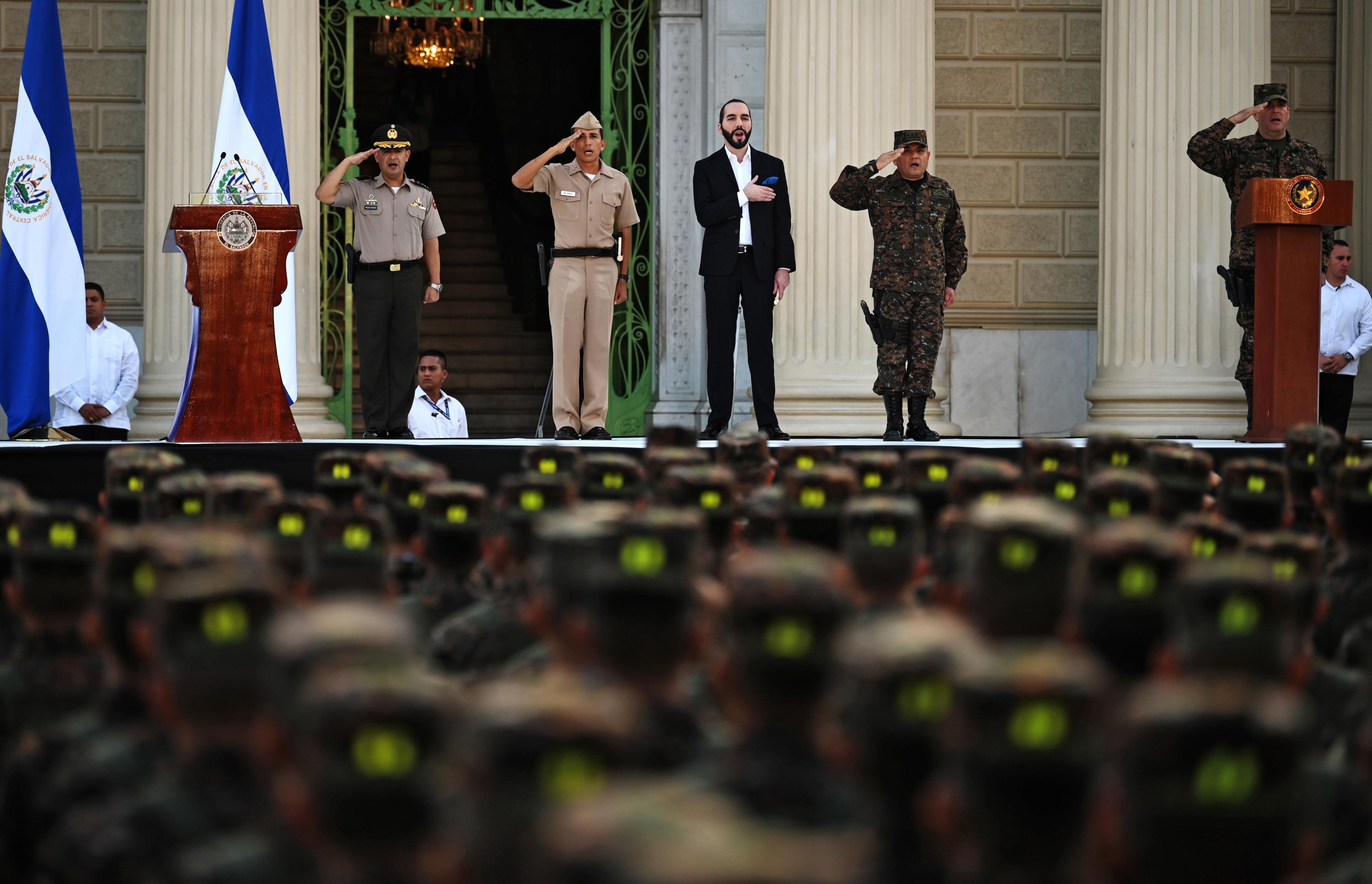 Photo Caption: President Nayib Bukele and minister of Defense, René Francis Merino Monroy, both center, during the swearing-in ceremony of 1,000 new soldiers to the Armed Forces on July 29, 2019. Photo courtesy AFP/Marvin Recinos