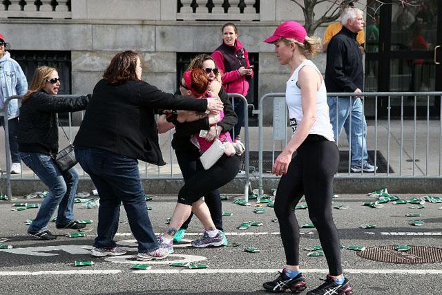 Una corredora abraza a una mujer cerca de la plaza Kenmor de Boston después de la explosión de dos bombas que mataron a dos personas cerca de la linea de meta de una carrera de maratón. Alex Trautwig (AFP)﻿" /></div> <figcaption class=