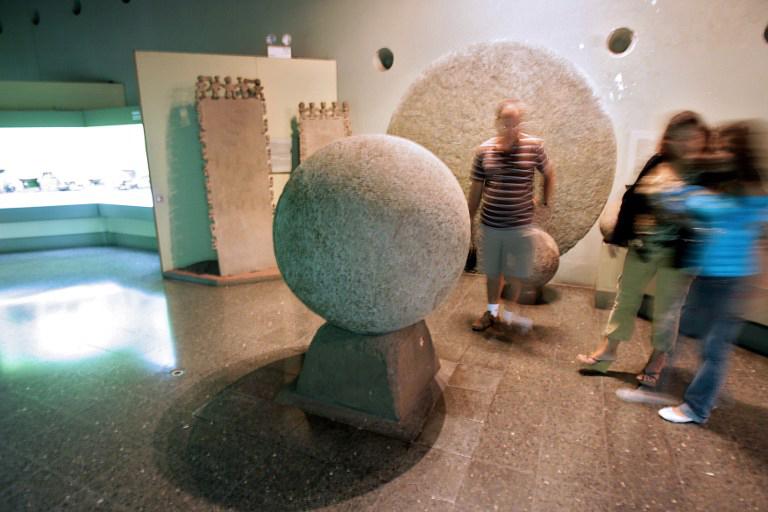 Visitantes observan una esfera de piedra precolombina encontrada al sur de Palmar en el delta de Diquís en el Museo Nacional de Costa Rica en San José. Foto | AFP